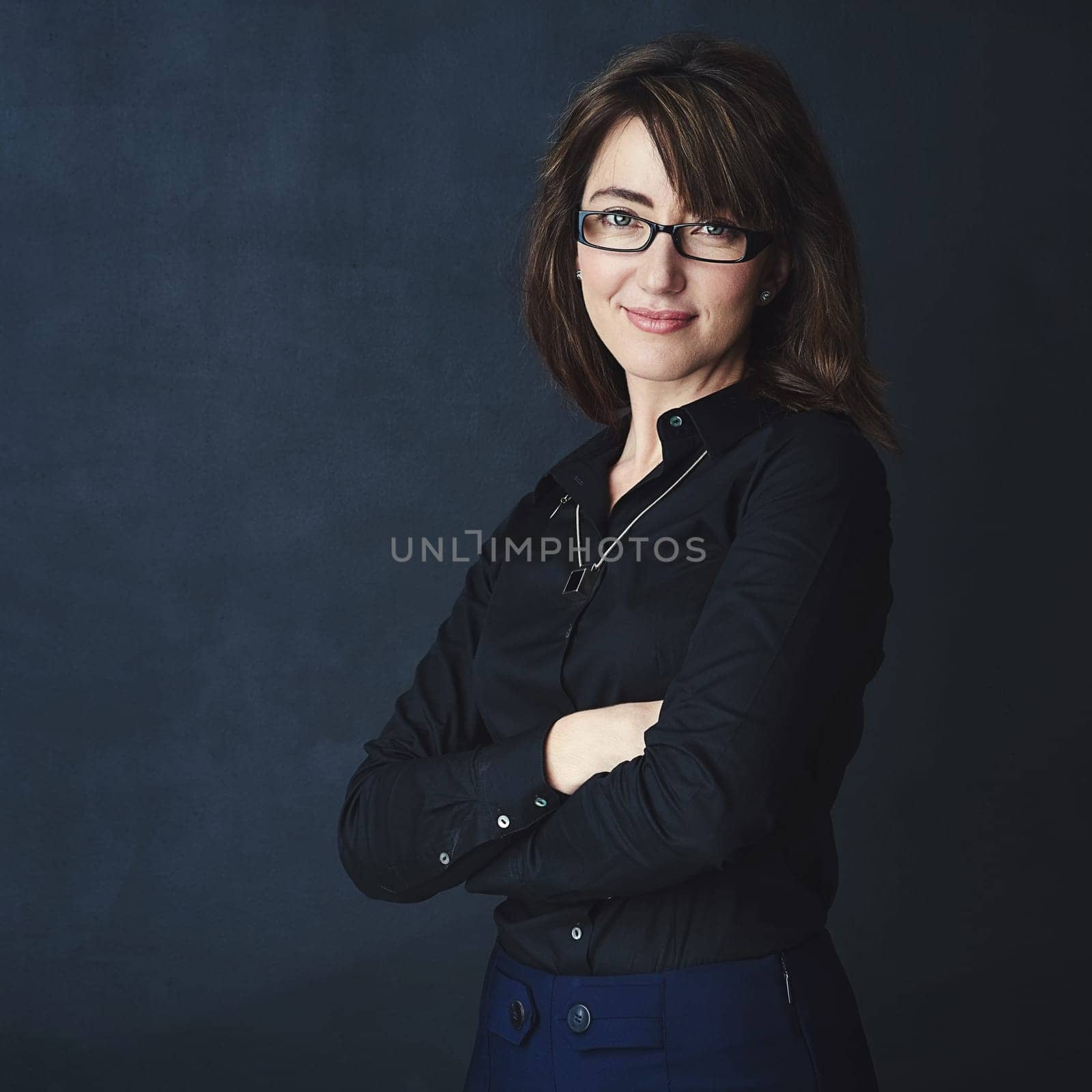 You have more potential than you believe. Studio portrait of a corporate businesswoman posing against a dark background. by YuriArcurs