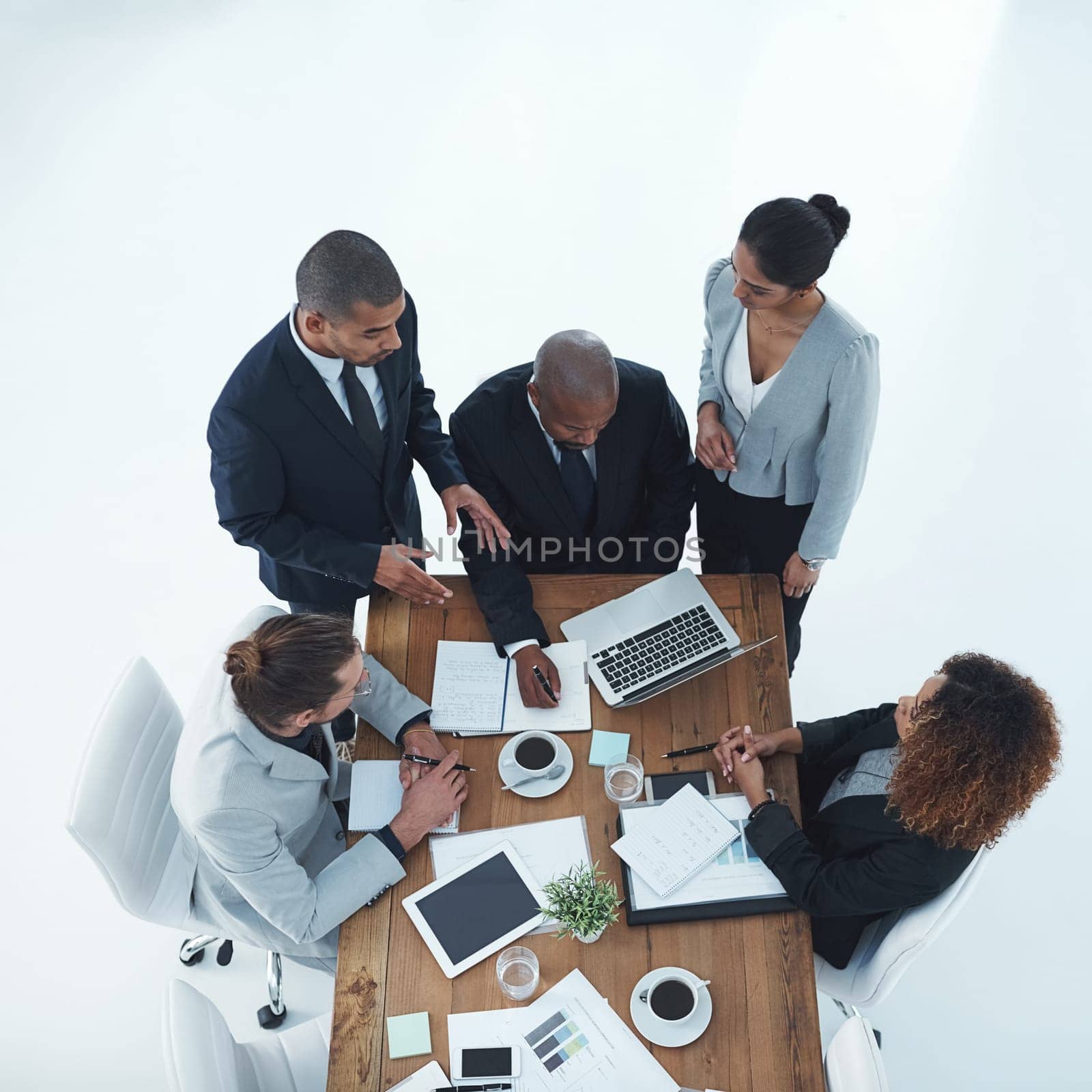 Project planning is a very important process. High angle shot of a group of businesspeople having a meeting. by YuriArcurs