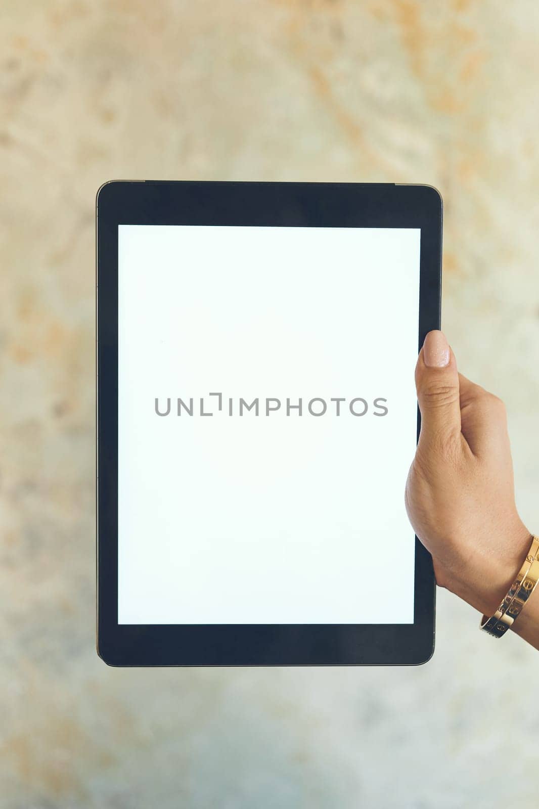 Heres another app worth downloading to your smart device. Closeup shot of an unrecognisable woman holding a digital tablet with a blank screen against a wall. by YuriArcurs