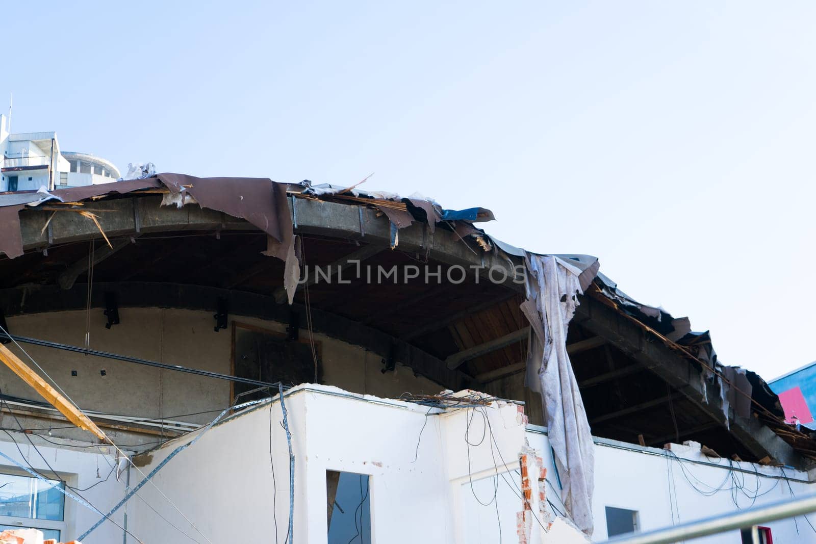 Background of process of demolition of building. Excavator breaking old house. by Zelenin