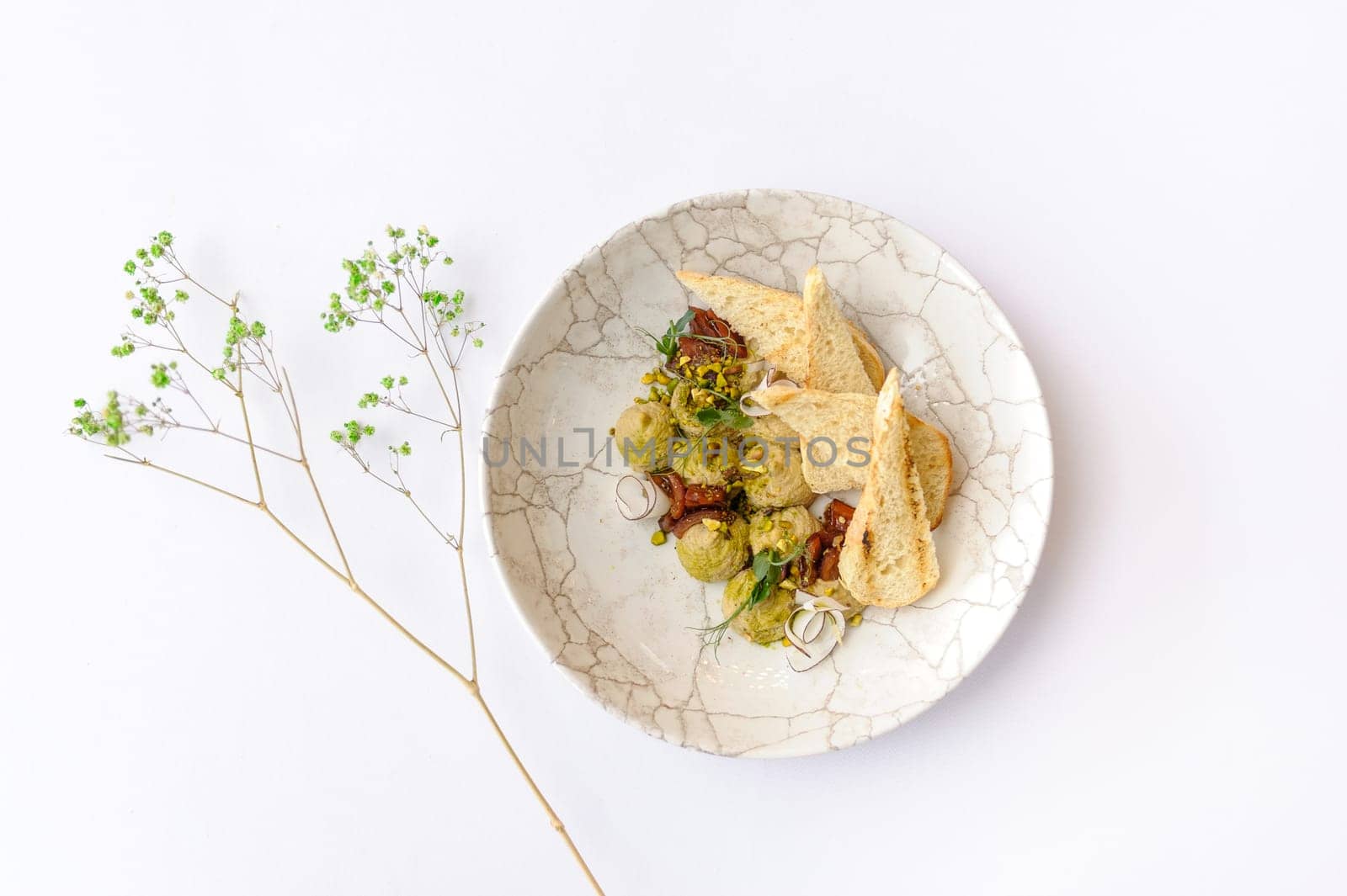 Hummus with pistachios, coconut and croutons