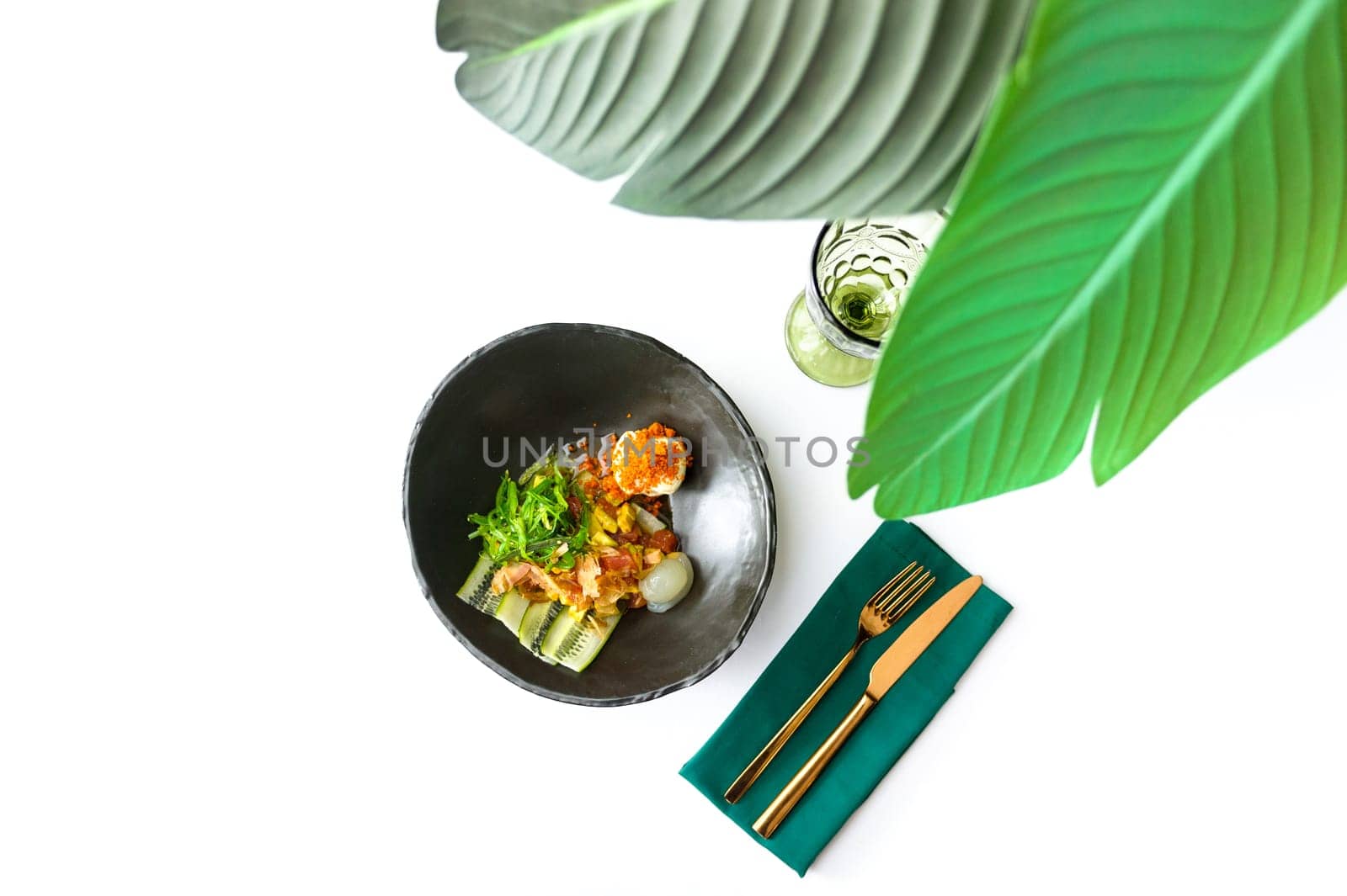 Salad with scallop, wakame, tuna flakes and avocado on a white background