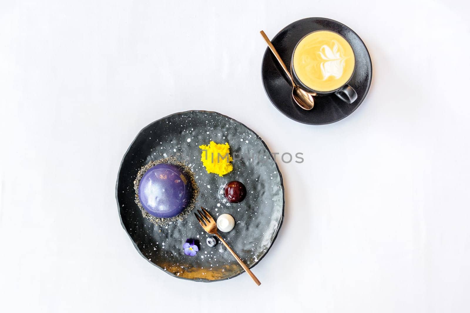 Space dessert on a black plate and a cup of coffee on a white background