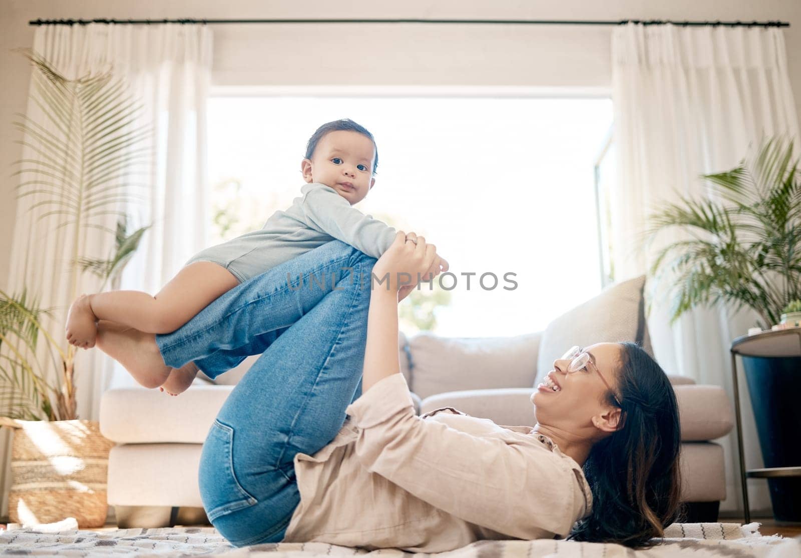 Home, love and mother play with baby for family bonding, quality time and child development together. New born, motherhood and happy mom carry infant for care, support and relationship in living room by YuriArcurs