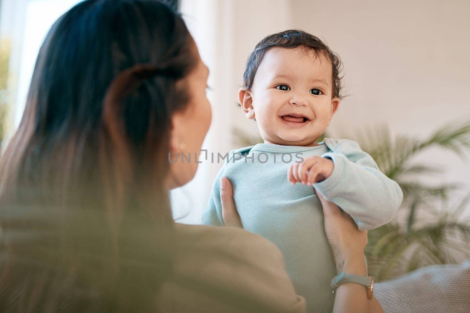 Family, love and mother play with baby for bonding, quality time and child development together at home. New born, motherhood and happy mom carry infant for care, support and affection in living room by YuriArcurs