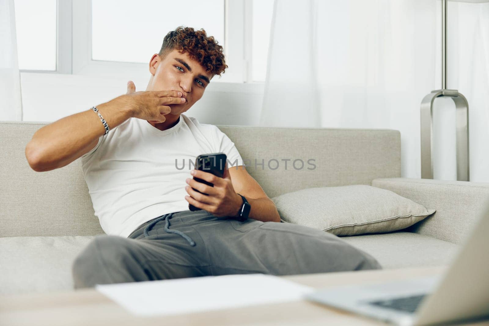 man interior sitting holding business online using mockup communication selfies text message technology blogger by SHOTPRIME