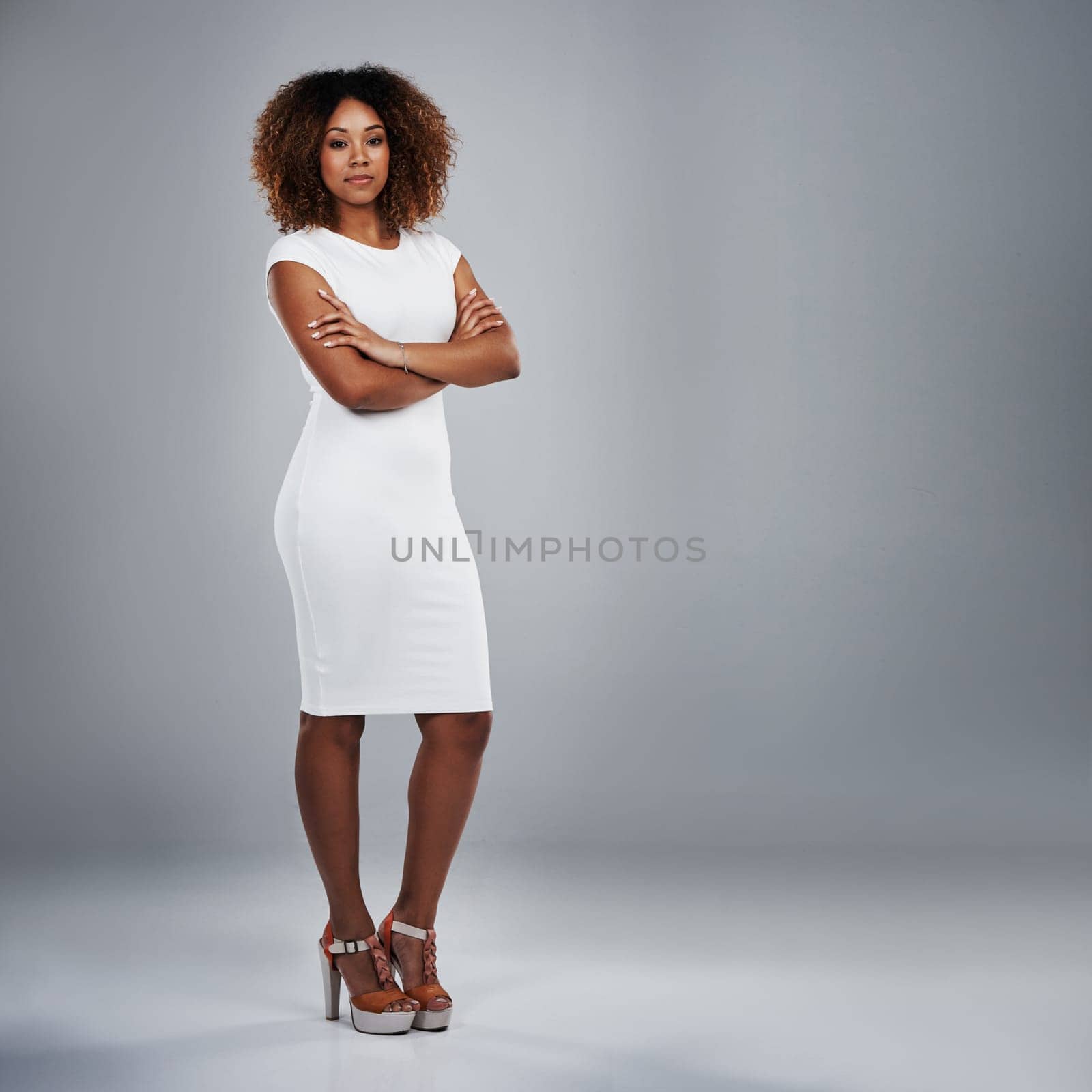 You have to want it more than anything. Studio shot of a young businesswoman against a gray background. by YuriArcurs