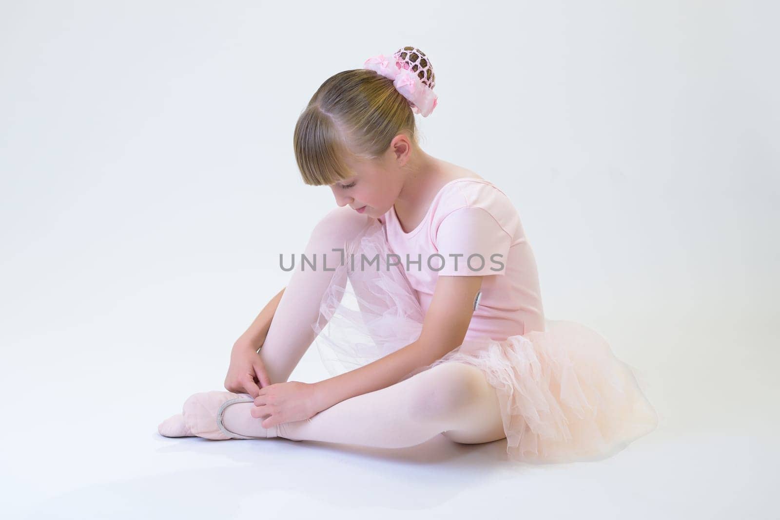 Dancing girl lying on the floor posing for the camera.
