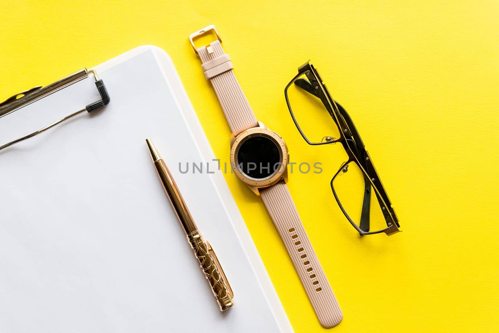 Home office workspace mockup with clipboard, glasses and accessories. Flat lay, top view.