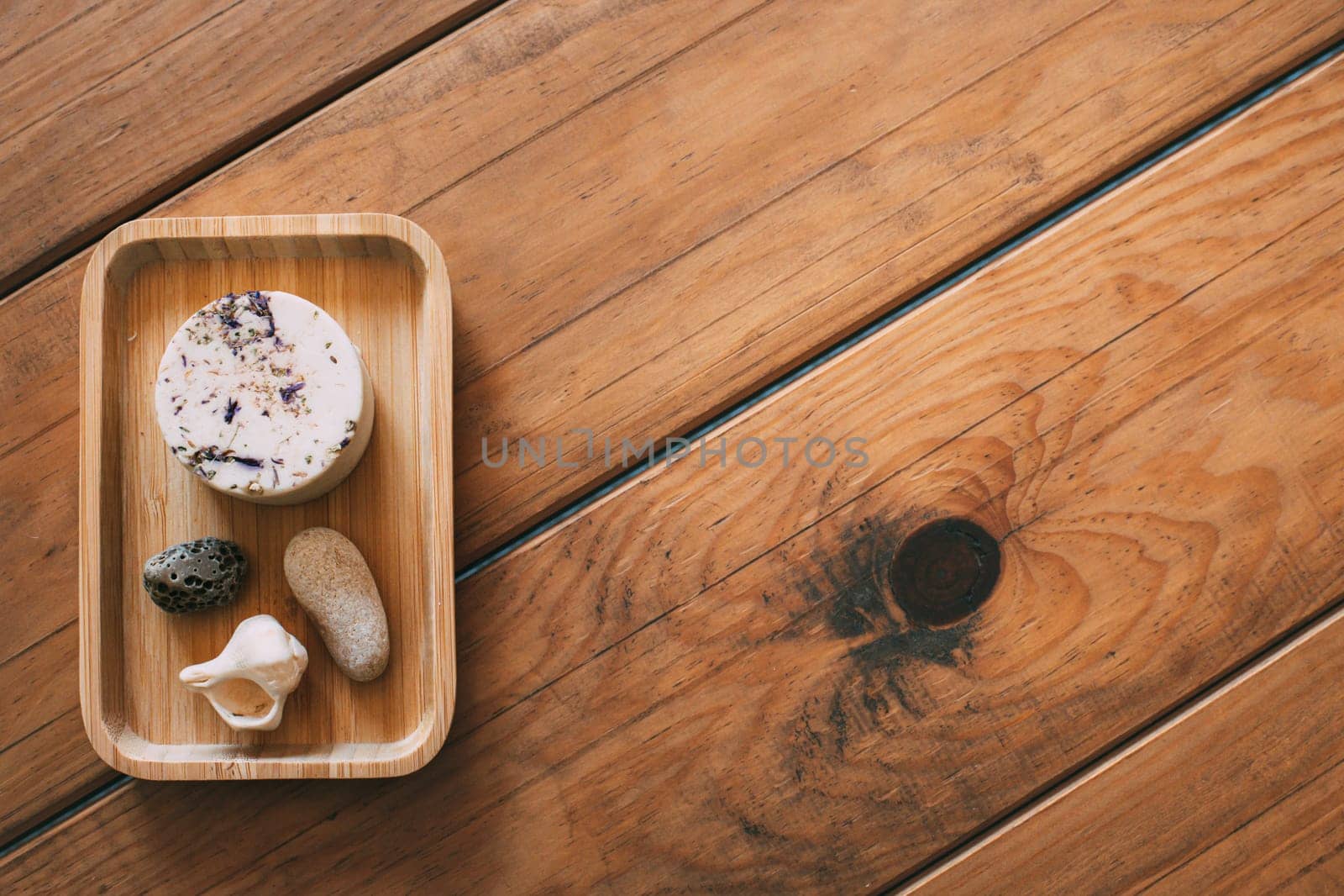 Solid natural handmade shampoo in wooden tray with natural wood base. space for copyspace. Zero waste concept. Ecological concept. Concept of environmental sustainability. Concept of personal hygiene by Hoverstock