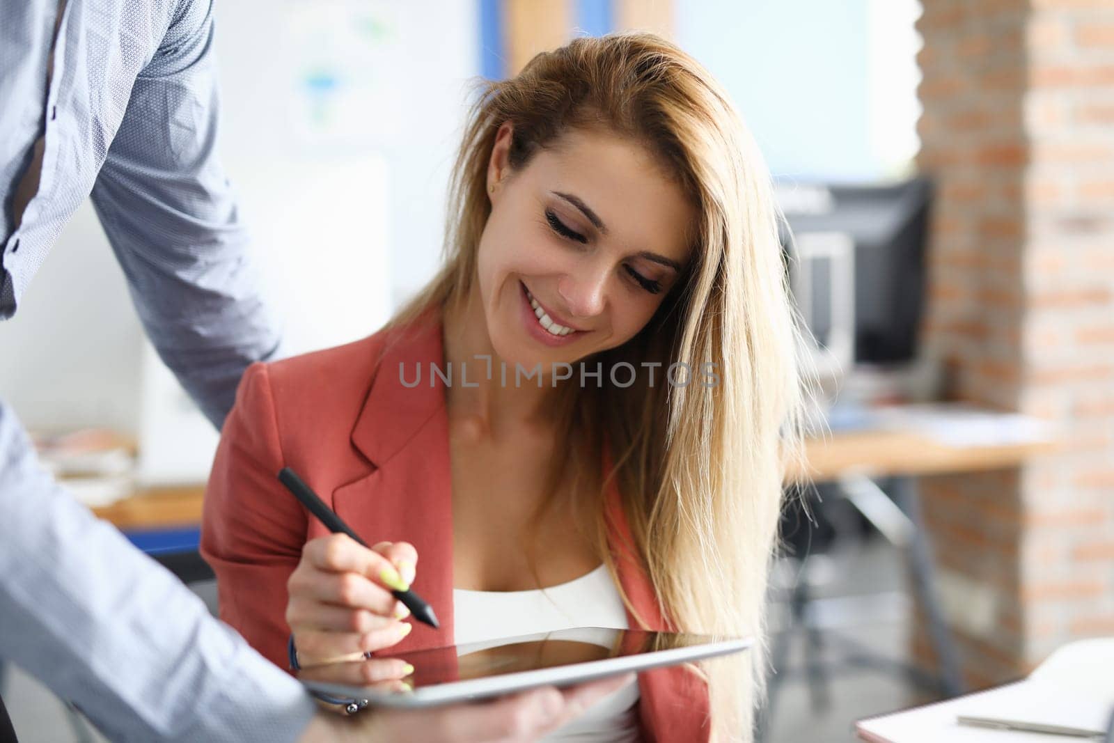 Business contract to digitally sign on tablet. Partner gives businesswoman tablet for electronic signature