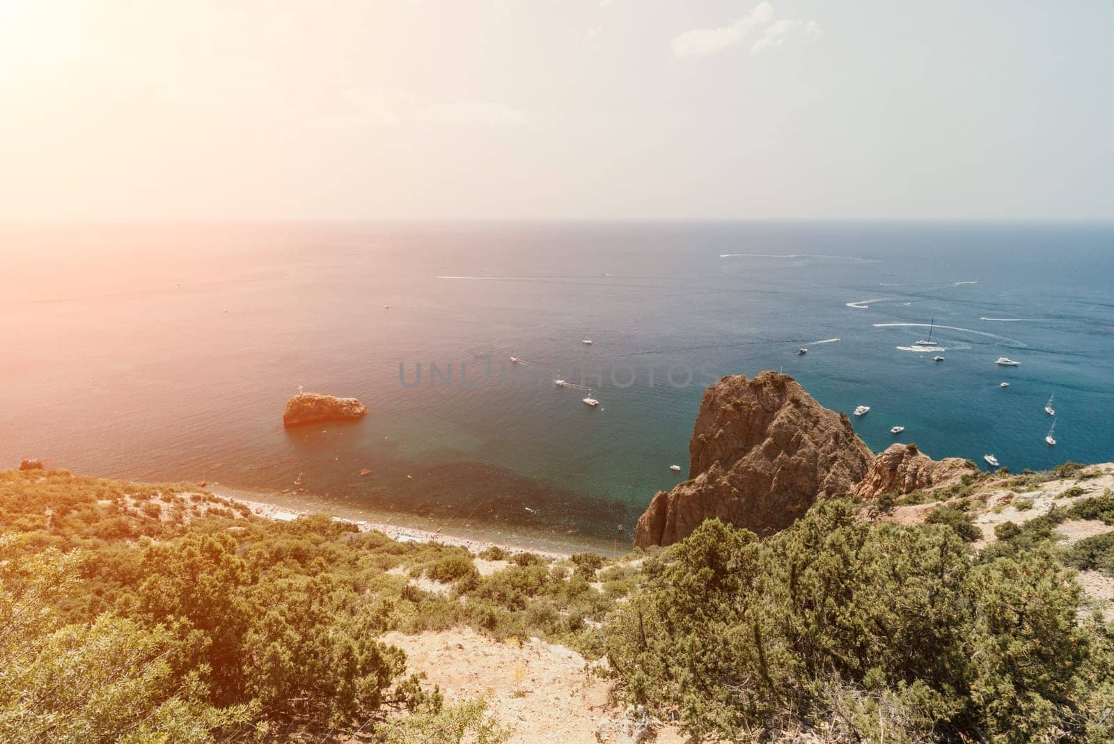 Aerial panoramic view of beautiful sunset above sea. Beautiful seascape. Sun glare, small waves on the water surface. Evening. Horizon. Nobody. No people. Copy space. Never-ending beauty of nature