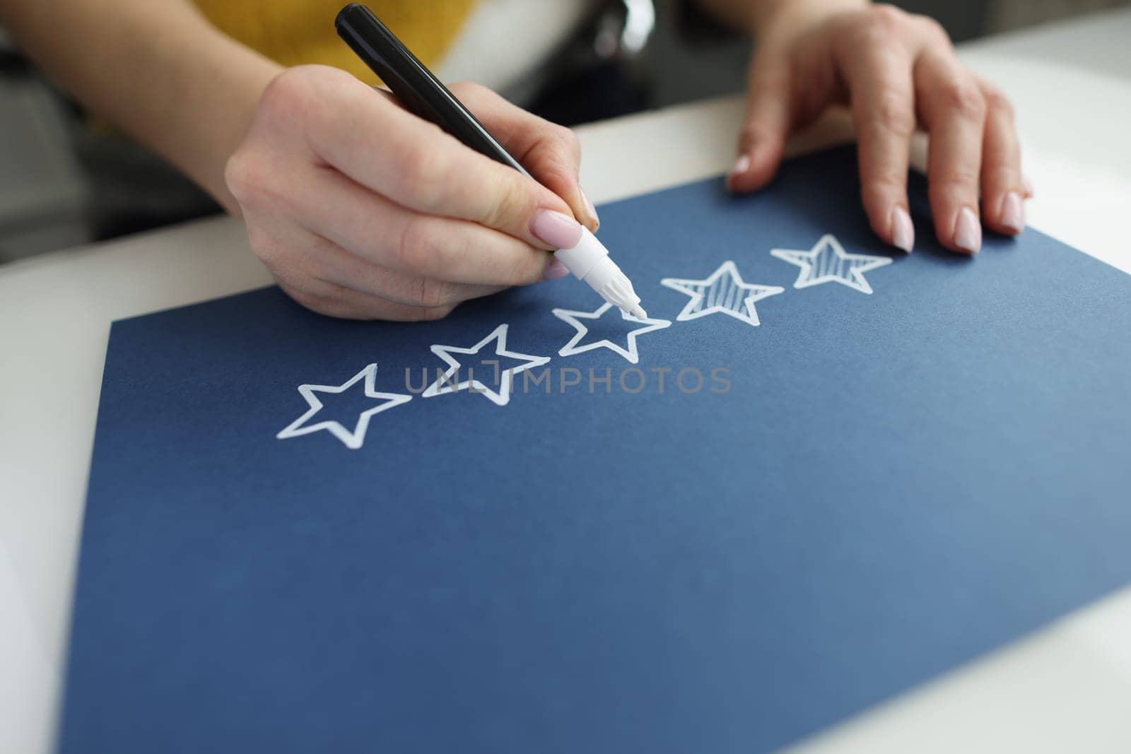 Person draws feedback feedback stars with star marker. Recommendation and rate us concept