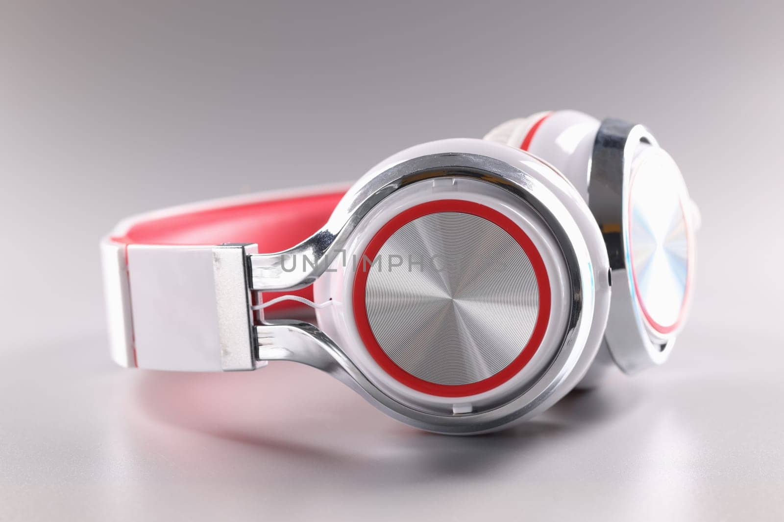 Modern red wireless headphones with white ear pads by kuprevich