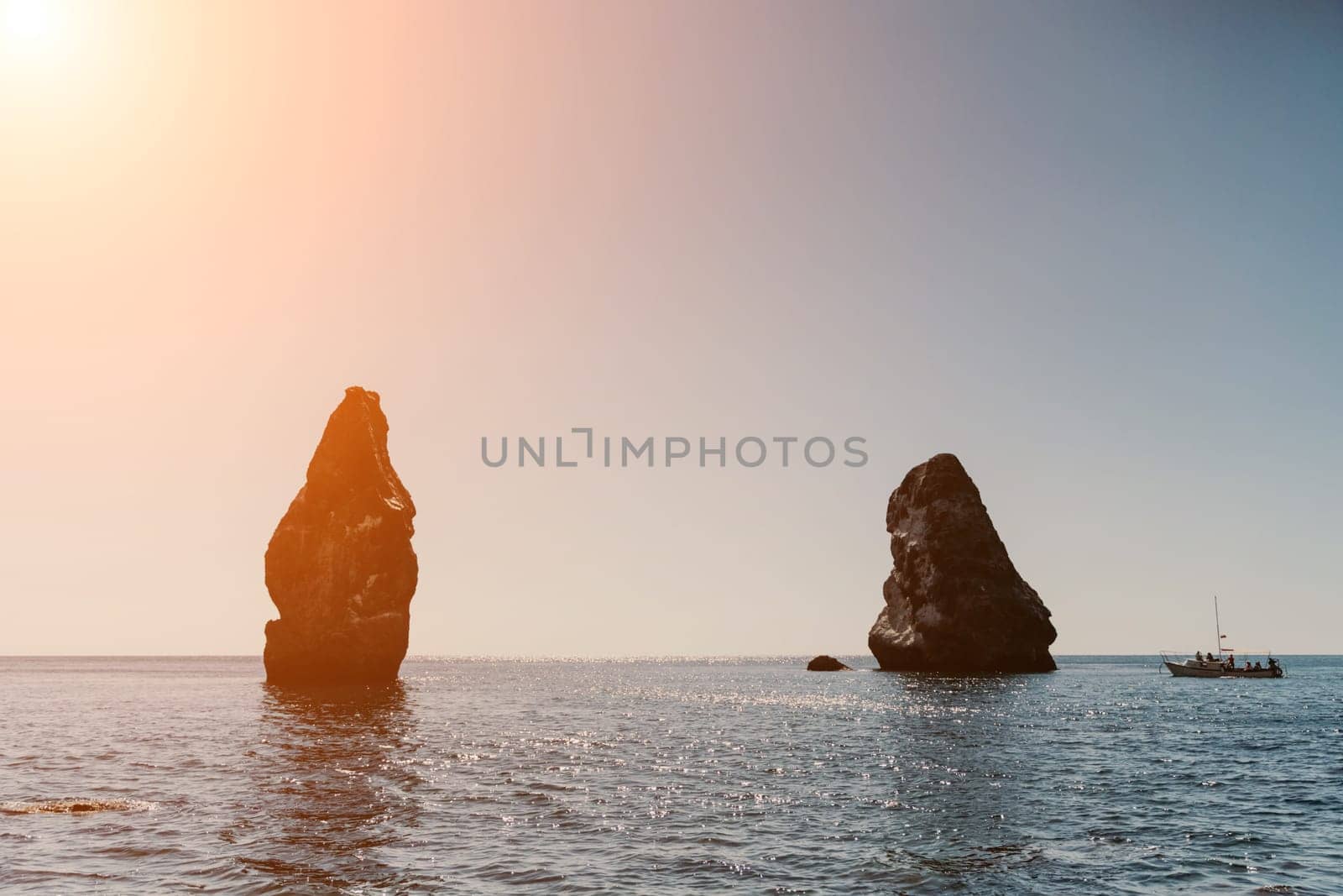 Two rocks stick out of the water in the middle of the turquoise sea. Scenic ocean views. High quality photo. Like in Iceland by Matiunina