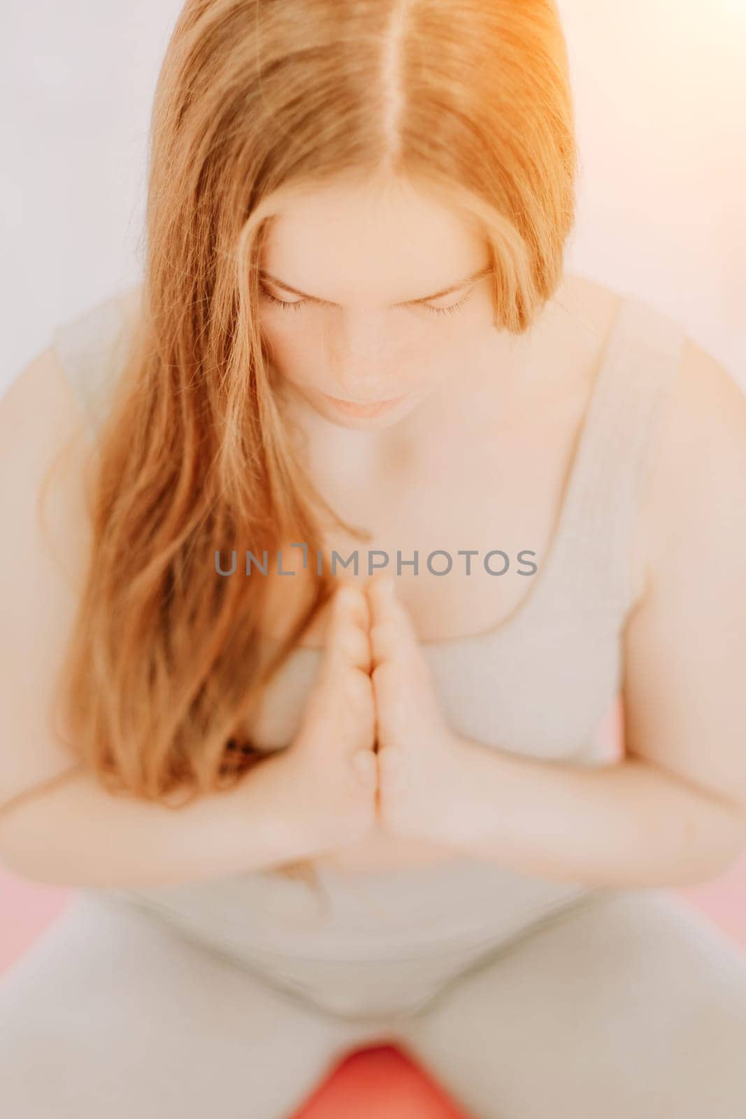 young sporty woman, fitness instructor in sportswear doing stretching and pilates on yoga mat in the studio with mirror. Female fitness yoga routine concept. Healthy lifestyle and harmony. by panophotograph