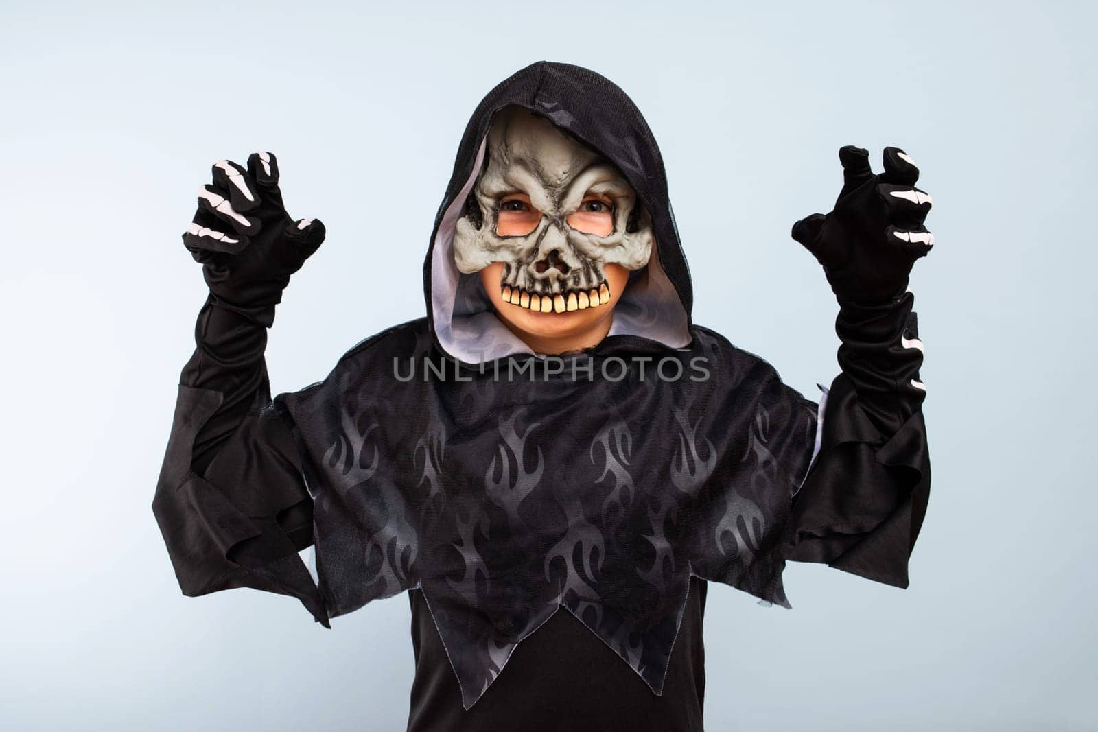 Portrait of angry little boy in halloween costume with frightening gesture by andreyz