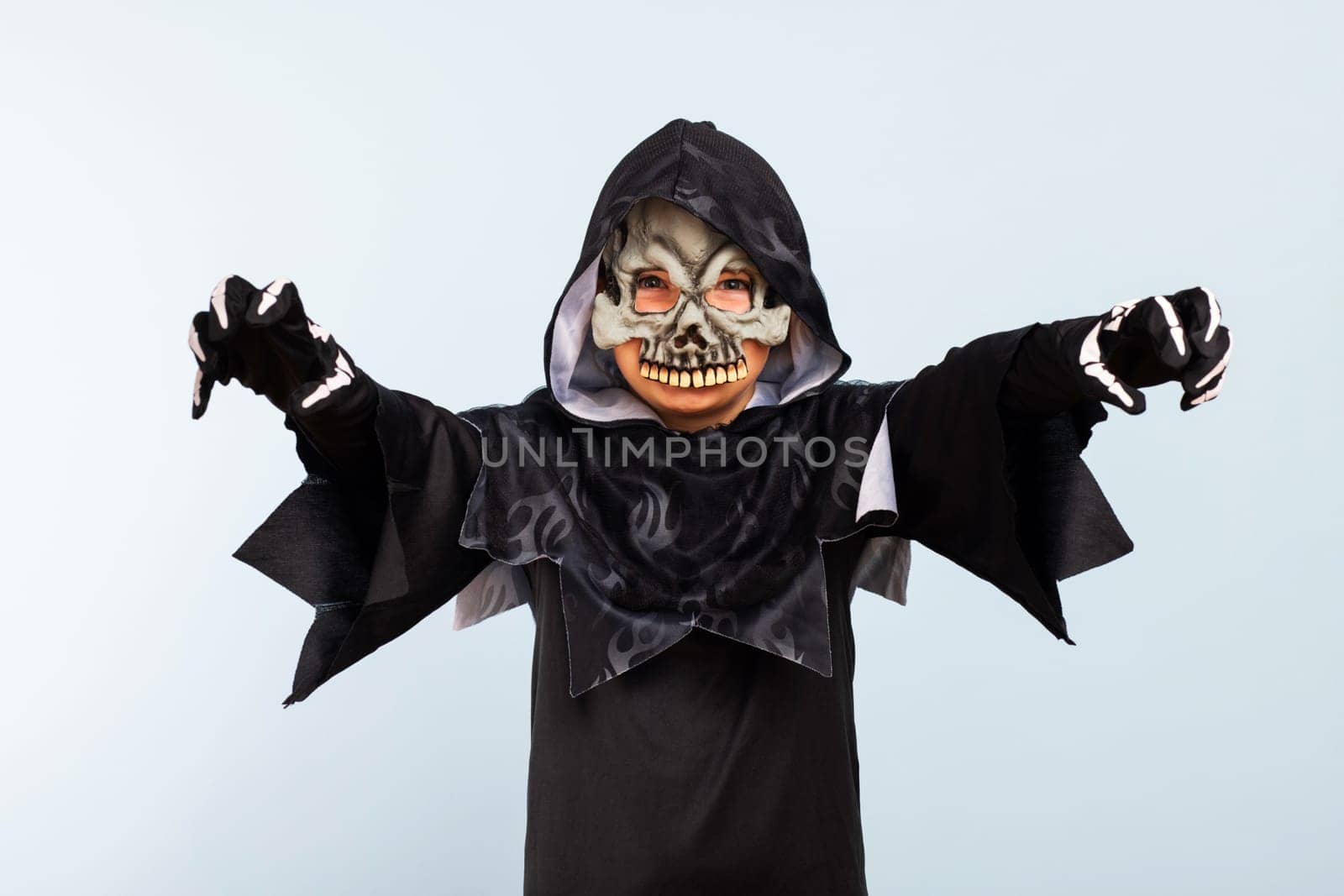 Happy Halloween. Portrait of an angry little boy in halloween costume with frightening gesture.