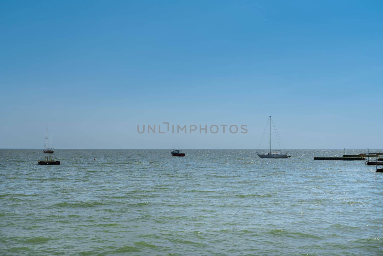 yachts on the water against the blue sky by roman112007