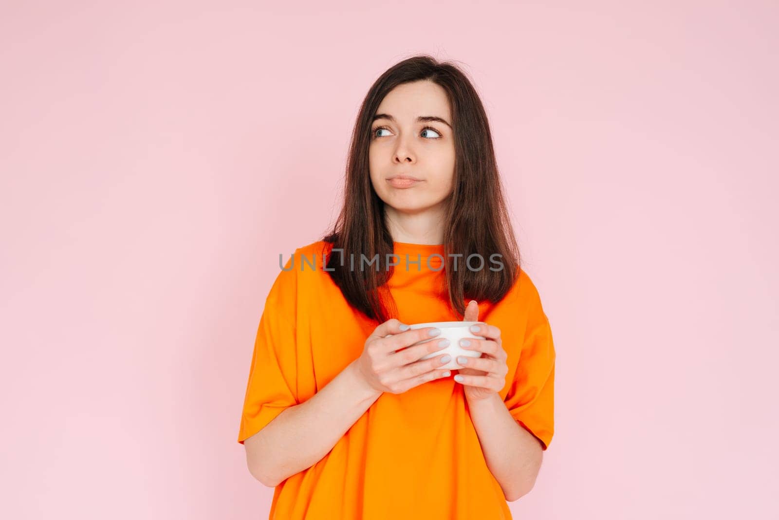 Sophisticated Taste: Elegant Woman Contemplating Drink Selection, Gazing at Empty Space - Decadence and Delightful Choices, Isolated on Pink Background