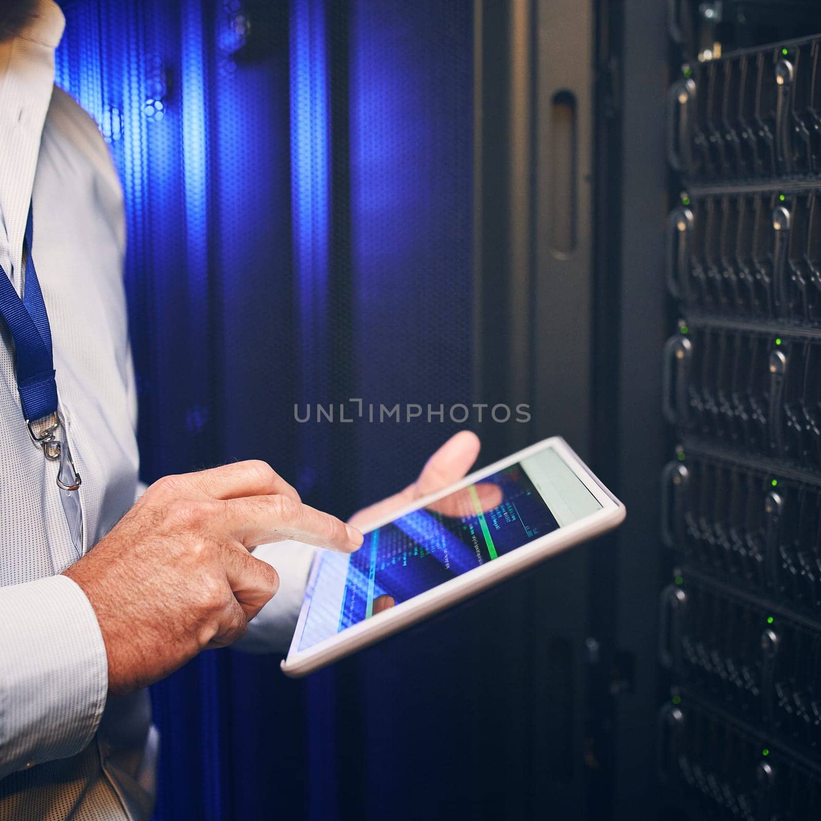 Put your companys network safety in the right hands. an unrecognisable man using a digital tablet while working in a server room. by YuriArcurs