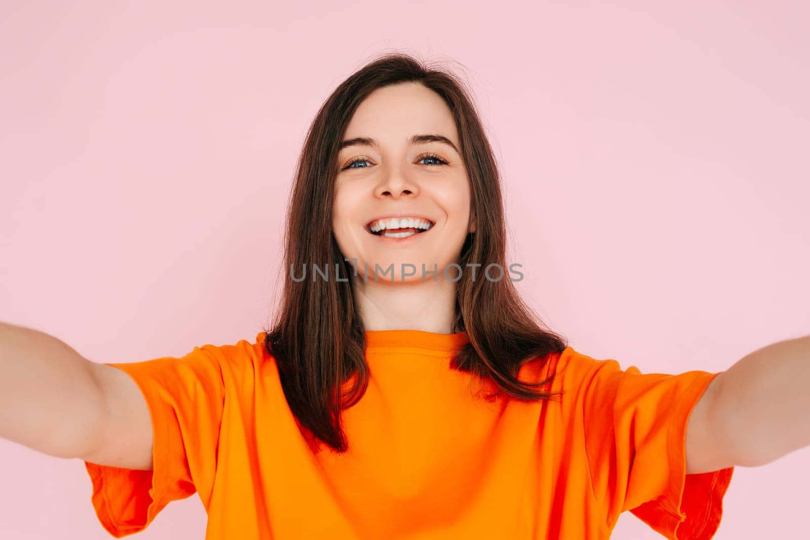 Vibrant Social Media Storytelling: Beautiful and Joyful Woman in Colorful Attire, Recording Instagram Twitter Post - Influencer and Informant Concept, Isolated on Pink Background. by ViShark