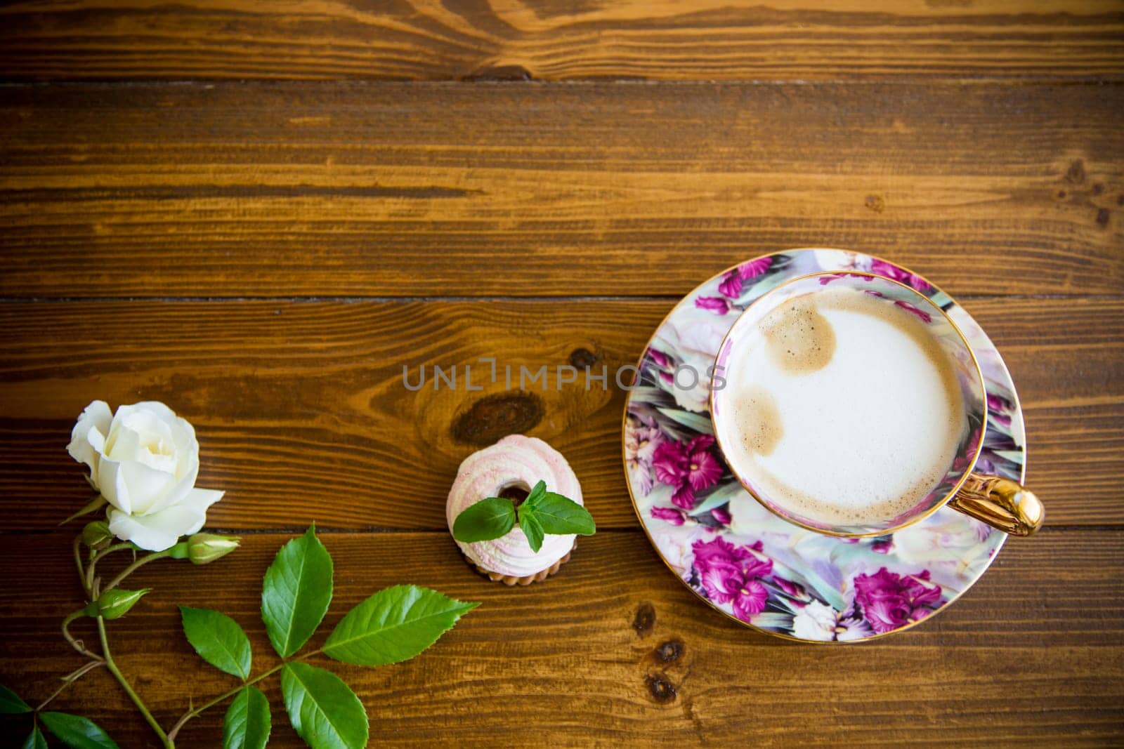 hot natural coffee with milk in a cup on a wooden table