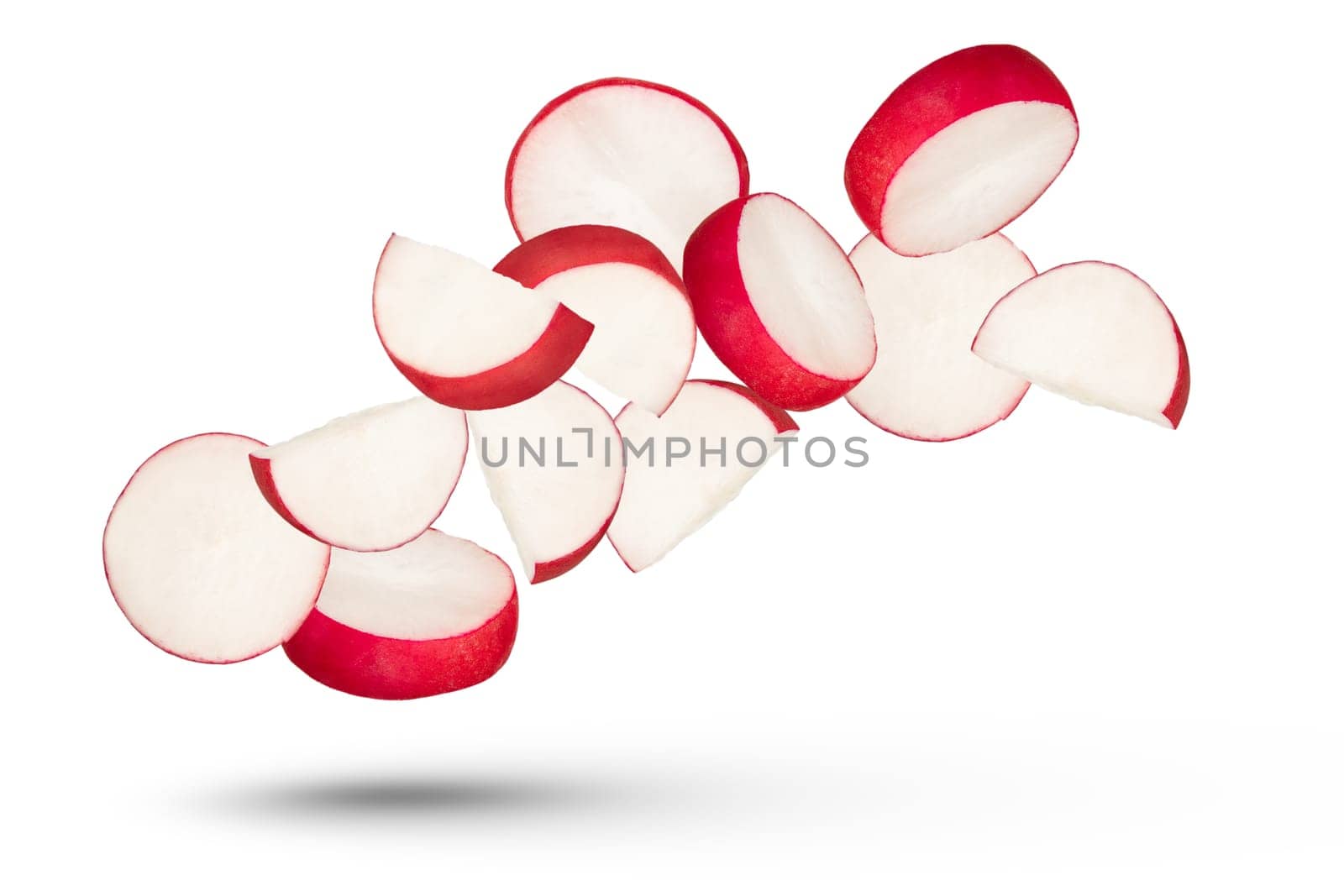 Radish slices isolated on white background. Many radish slices fall at different angles on a white background. The concept of the season of vegetables and the preparation of delicious, healthy food. by SERSOL