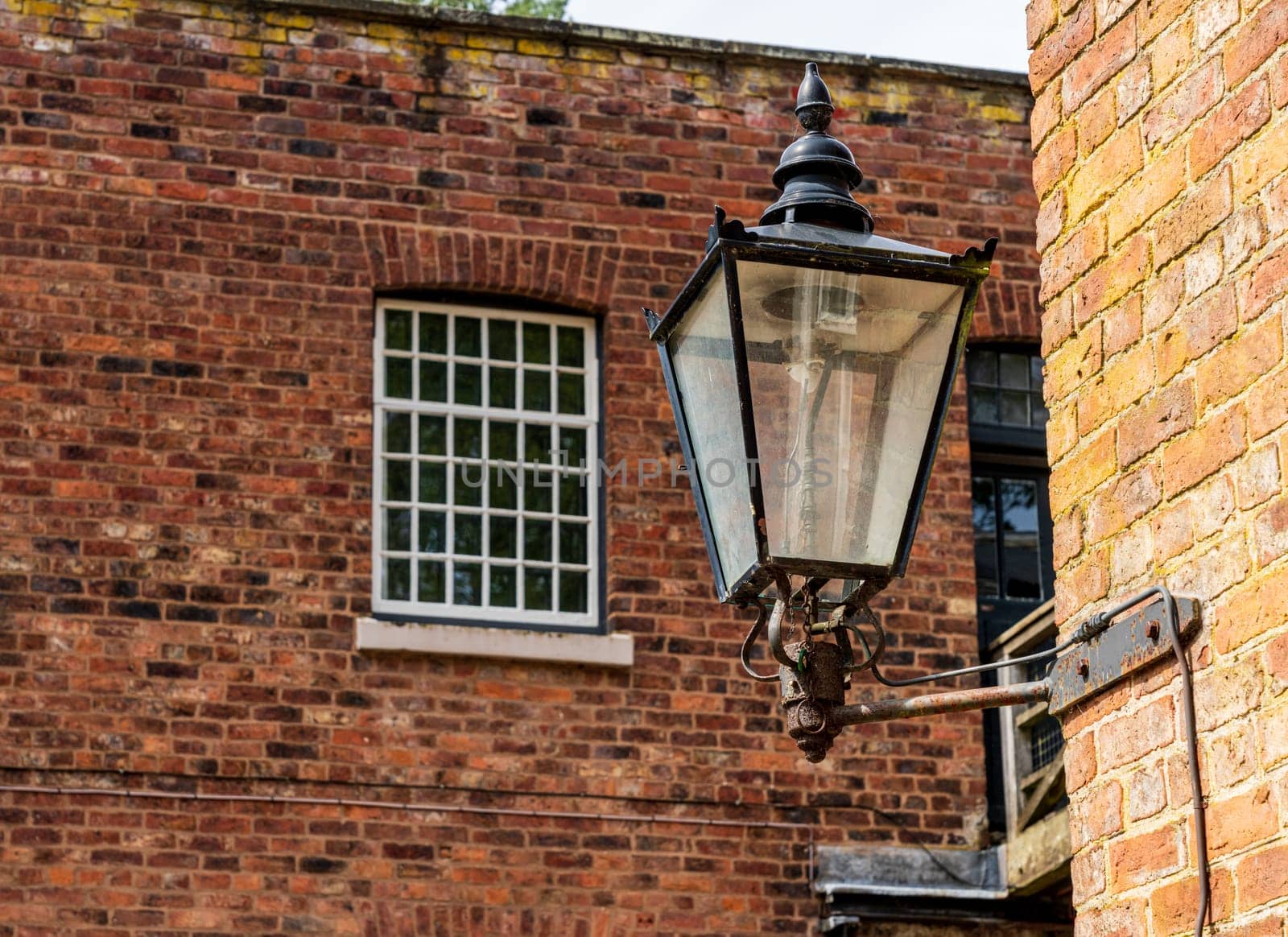 Restored industrial cotton mill with old gas light by steheap