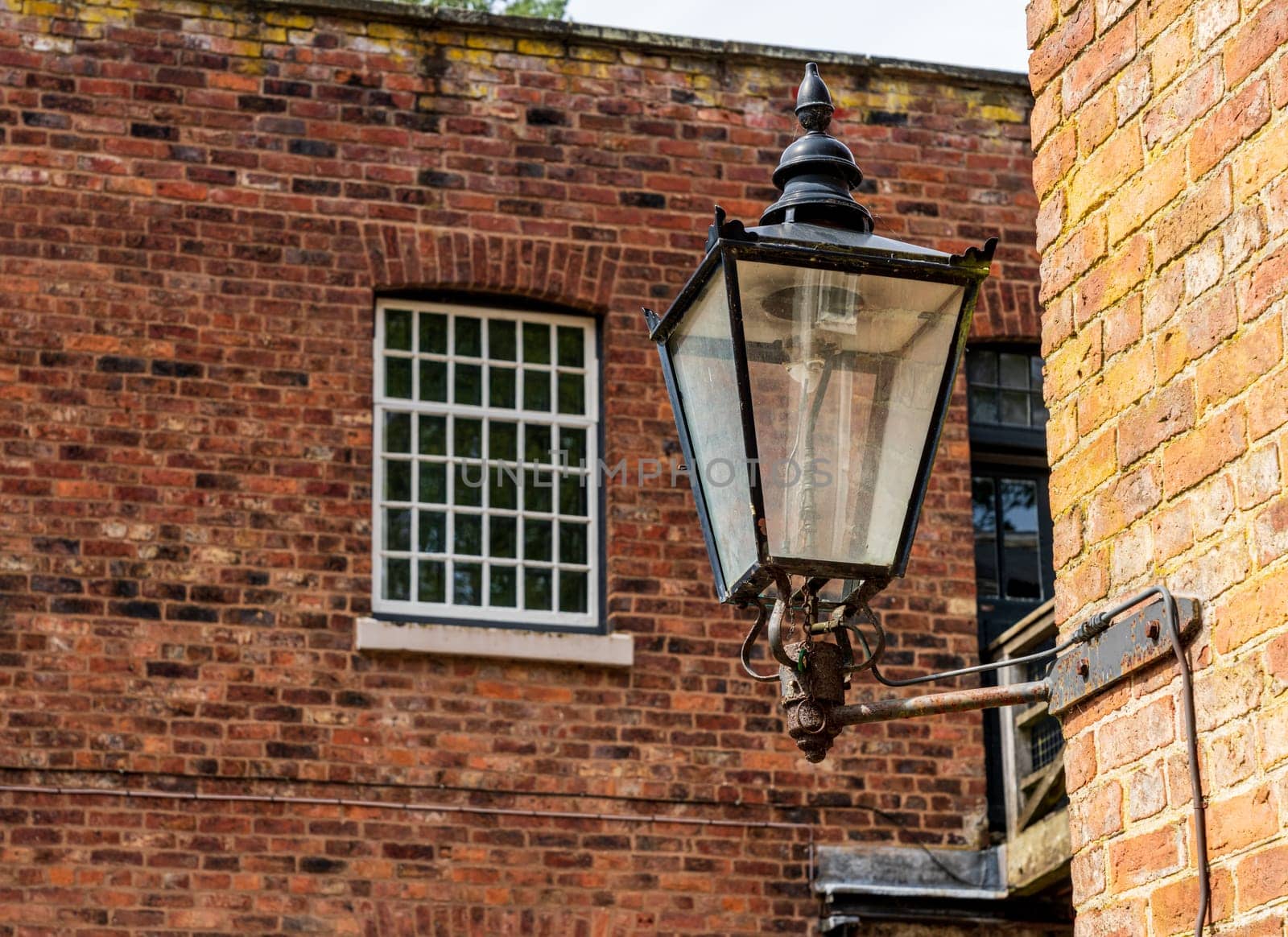 Exterior of restored cotton spinning and weaving mill in north of England with focus gas light