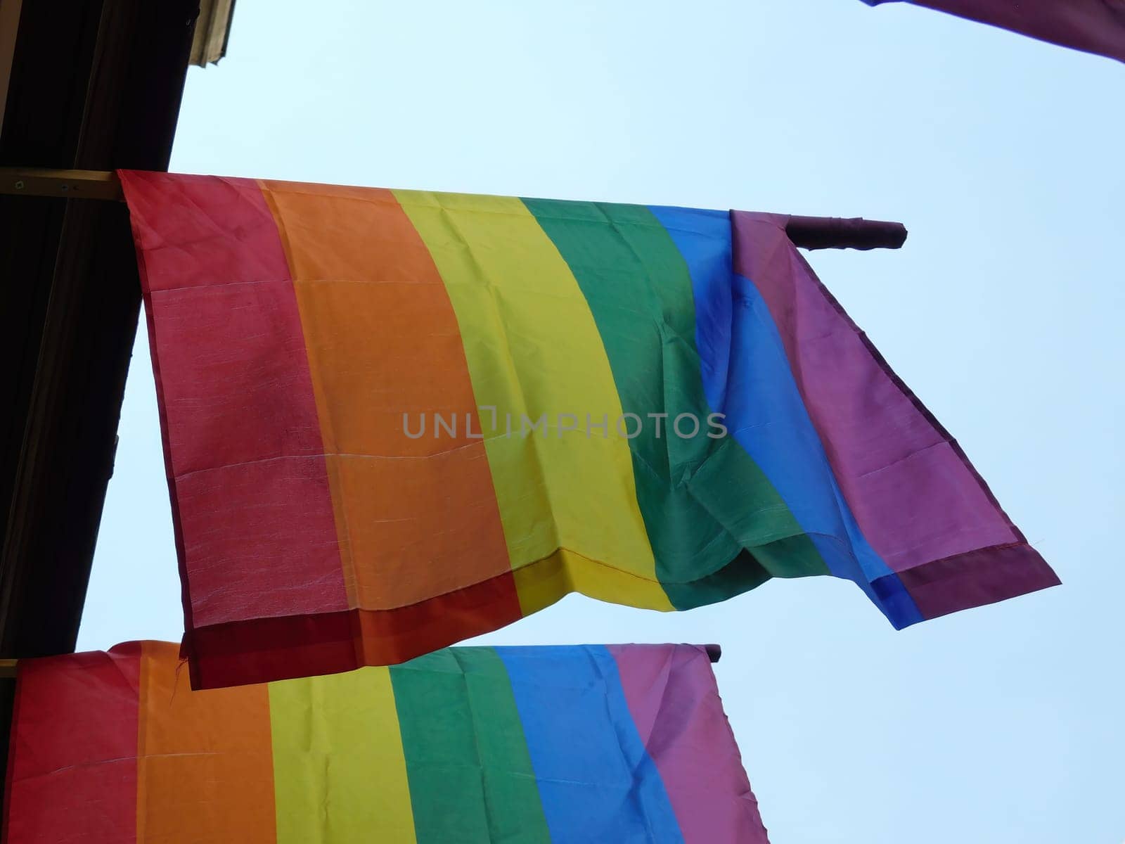 Pride rainbow lgbt gay flag being waved on sky bg