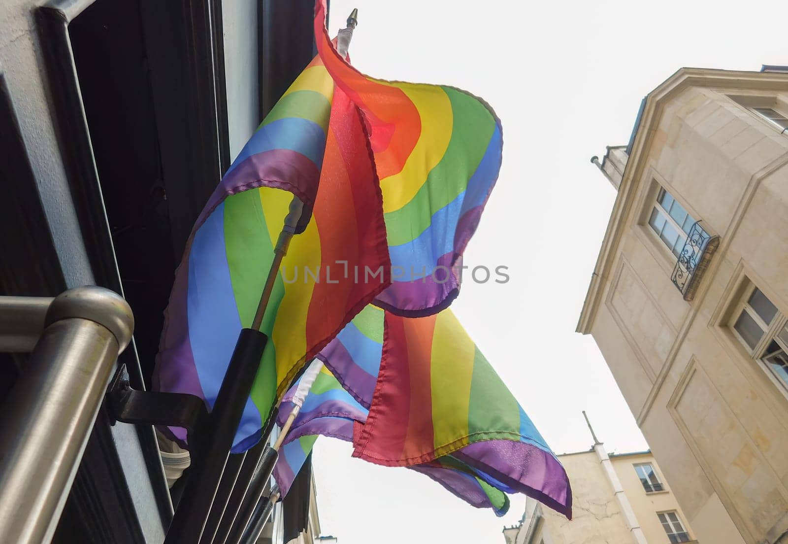 Pride rainbow lgbt gay flag being waved on sky background by Whatawin