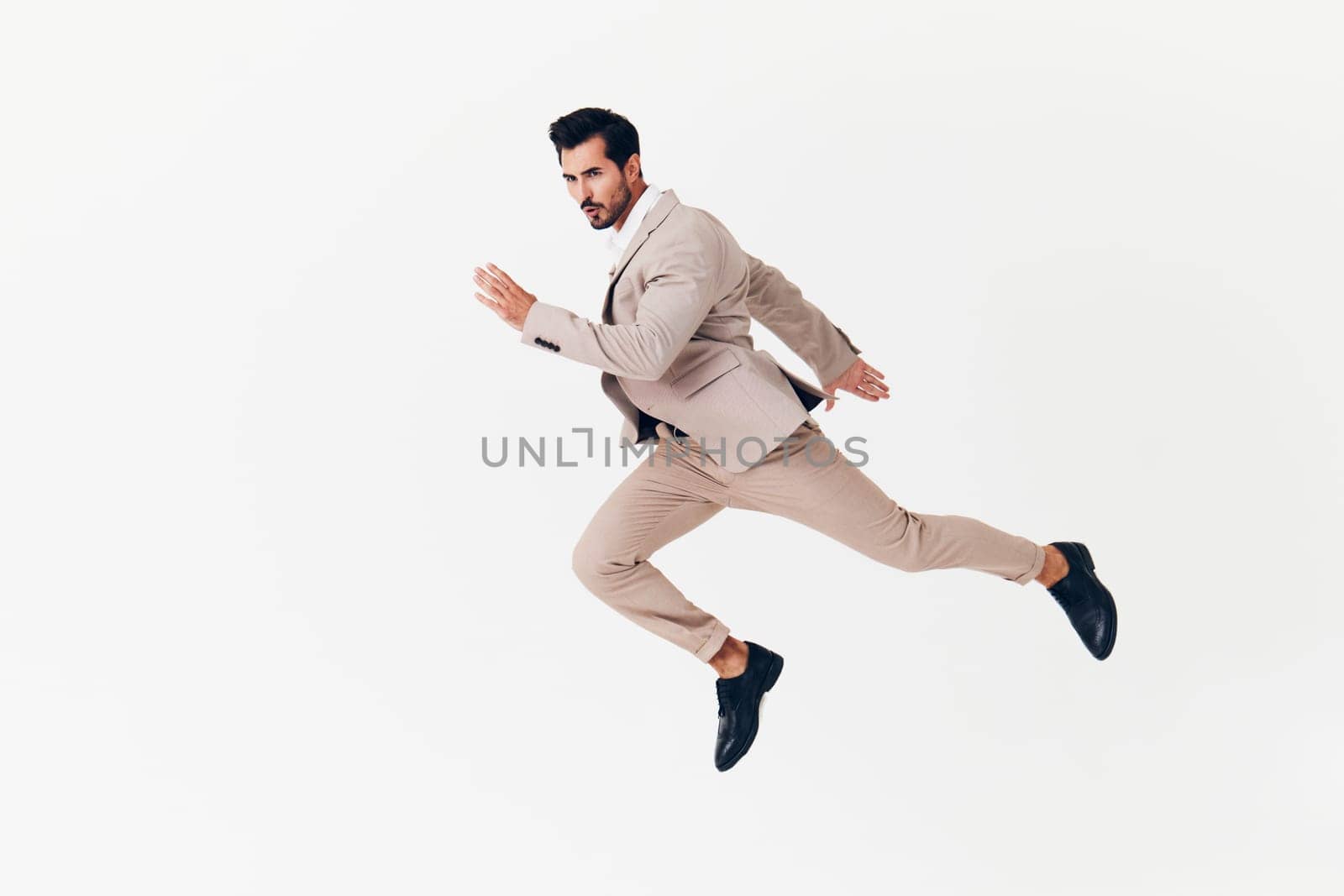 man beige smiling suit victory winner businessman attractive running business happy by SHOTPRIME