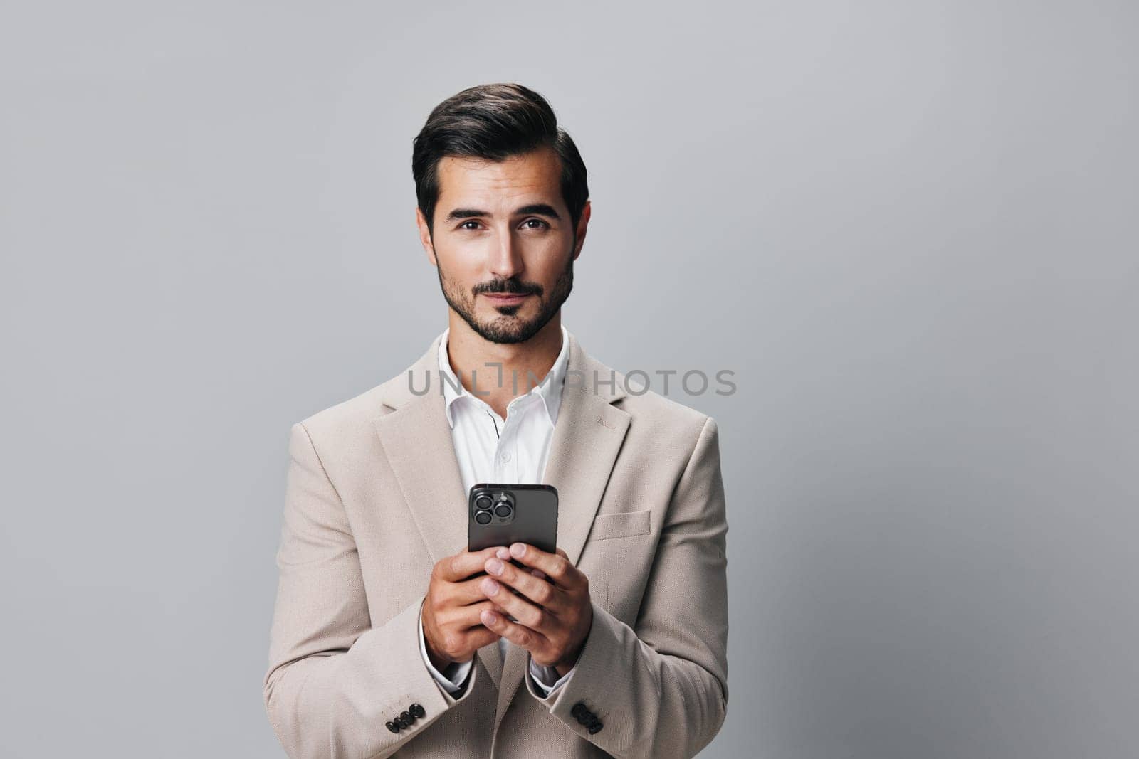 man phone suit portrait happy beige smile hold business call smartphone by SHOTPRIME