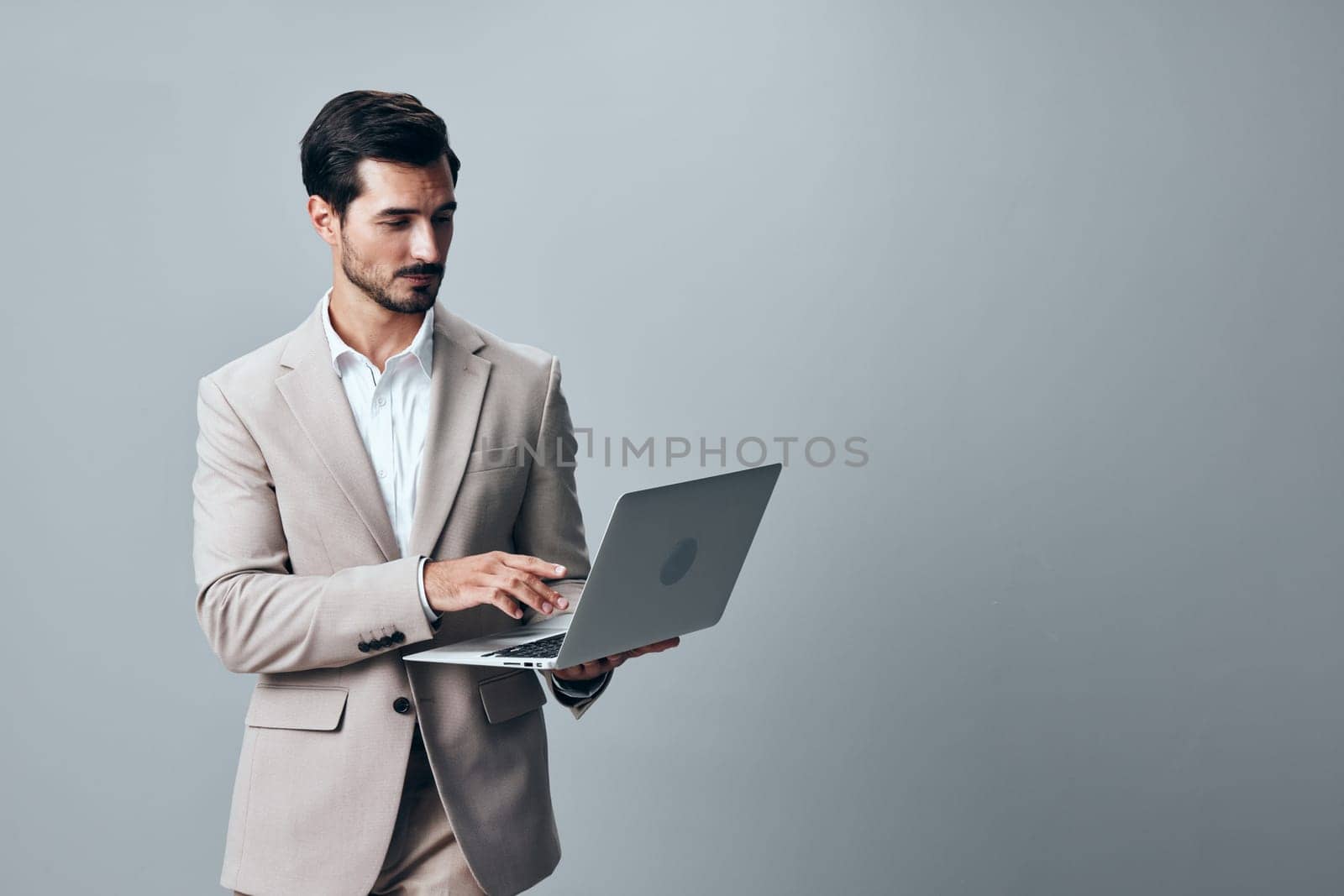 man young smiling computer stylish freelancer online internet suit adult male cyberspace person beige professional laptop using copyspace job wireless business