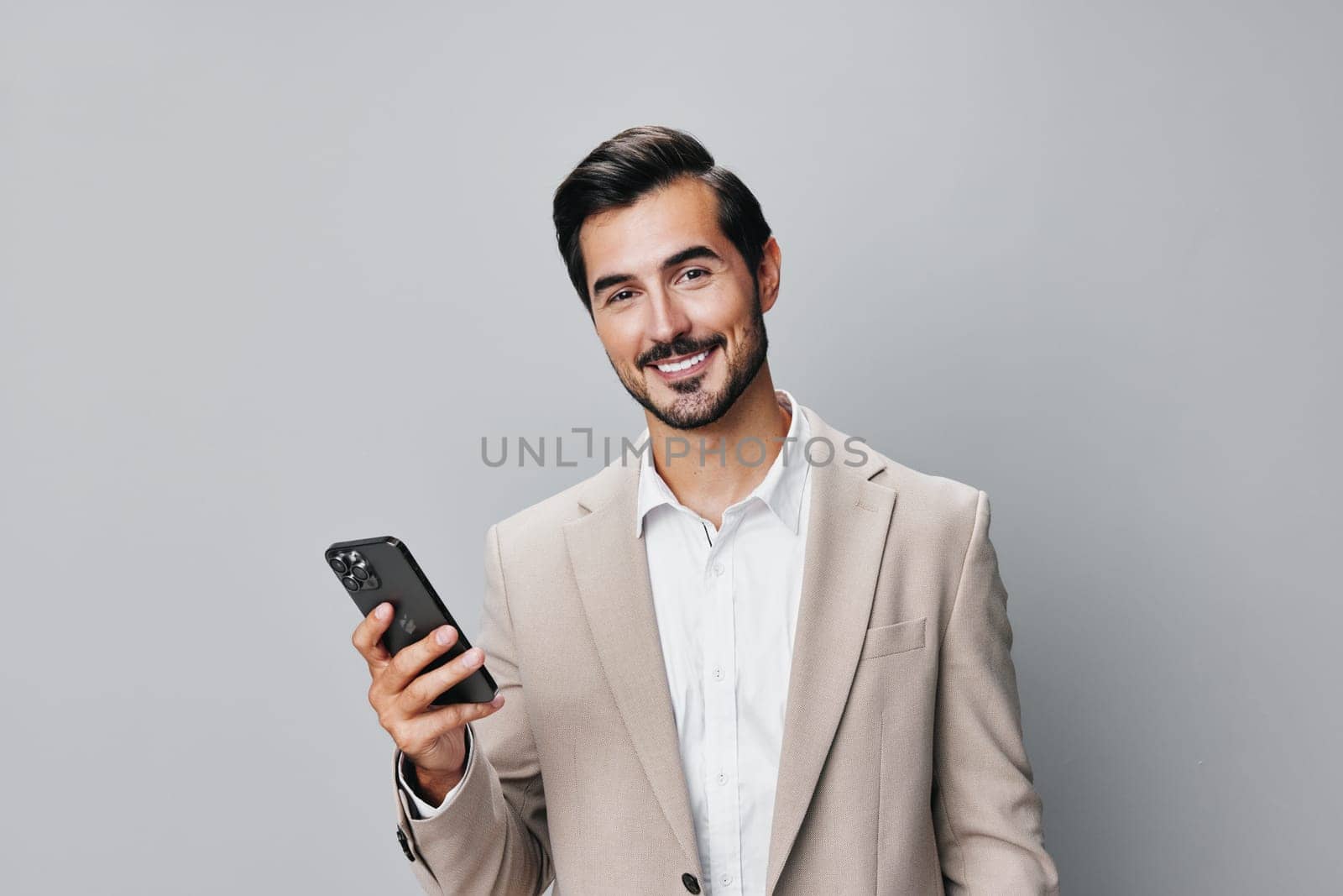 man gray hold happy business portrait phone smile smartphone suit call by SHOTPRIME