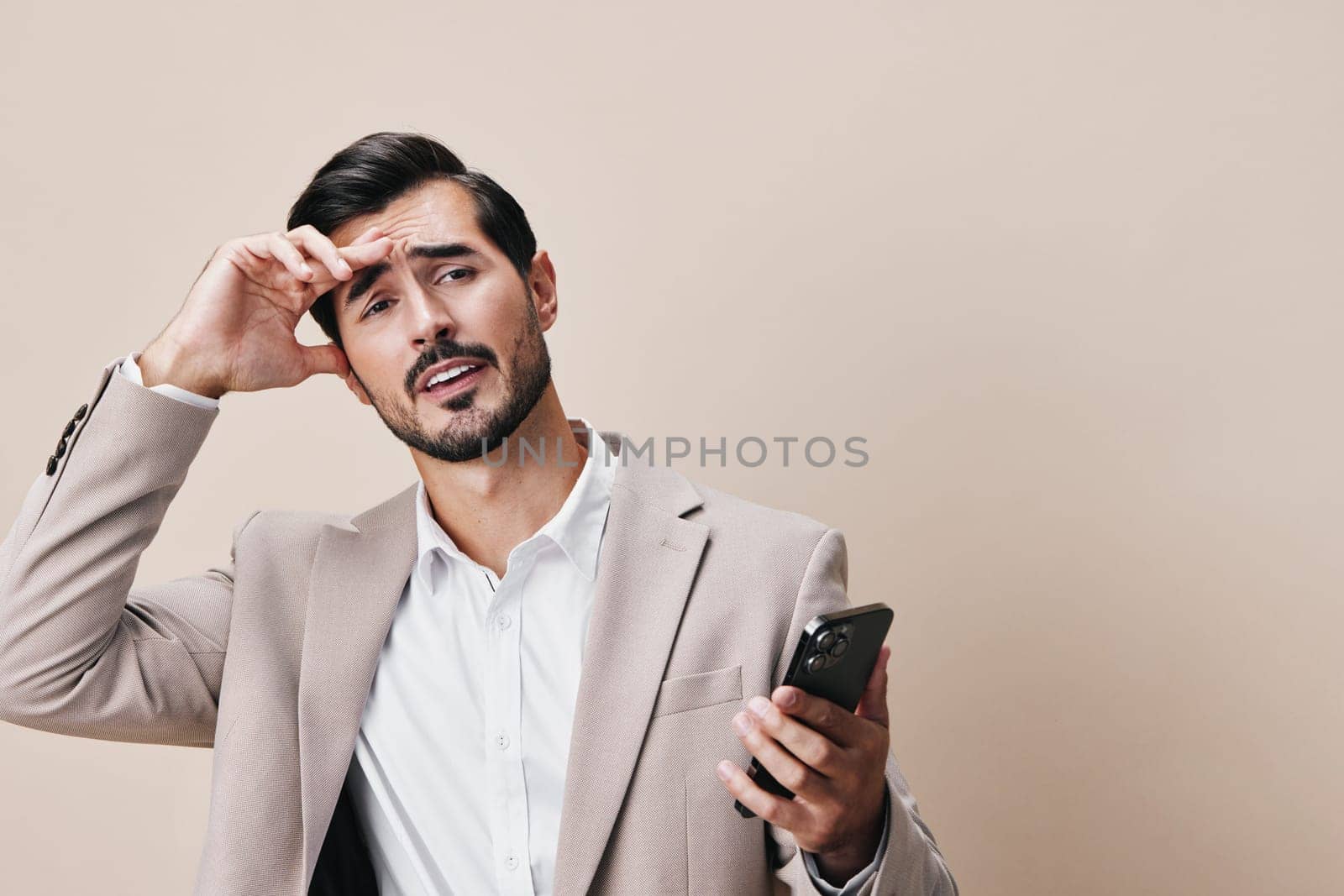 man beard studio holding handsome phone technology hold background trading isolated call happy business smile lifestyle portrait cellphone smartphone suit communication selfies