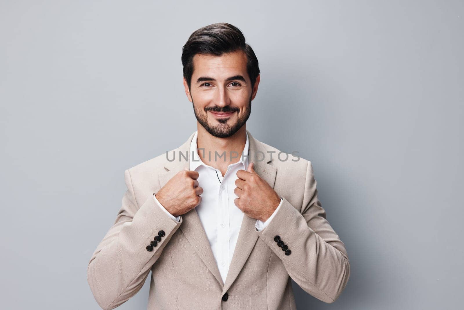 man standing copyspace crossed studio suit portrait business corporate formal smiling professional posing beige handsome happy arm businessman sexy isolated success