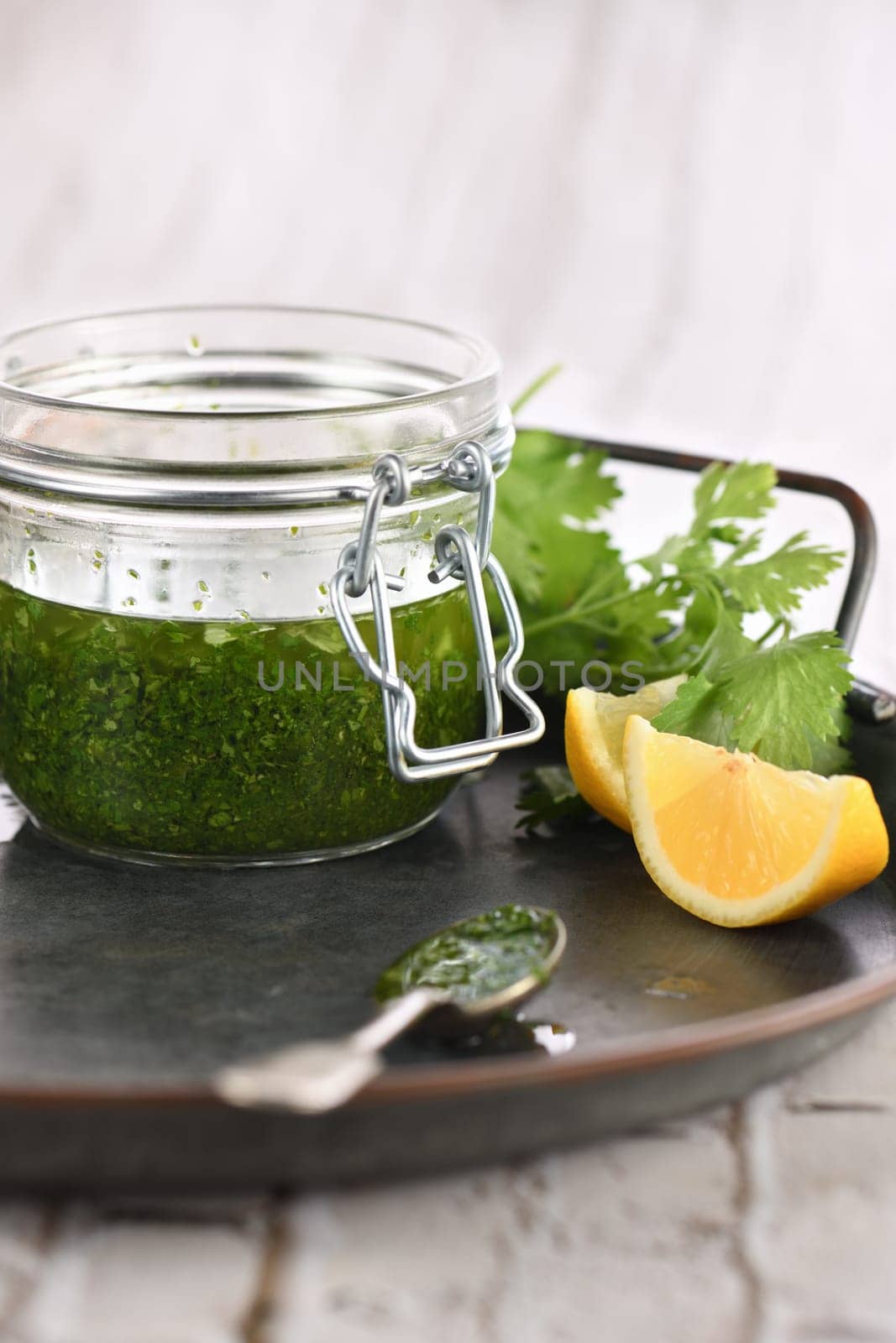 Green delicious herbal marinade of cilantro, basil, parsley, oil, traditional seasoning for salad dressing