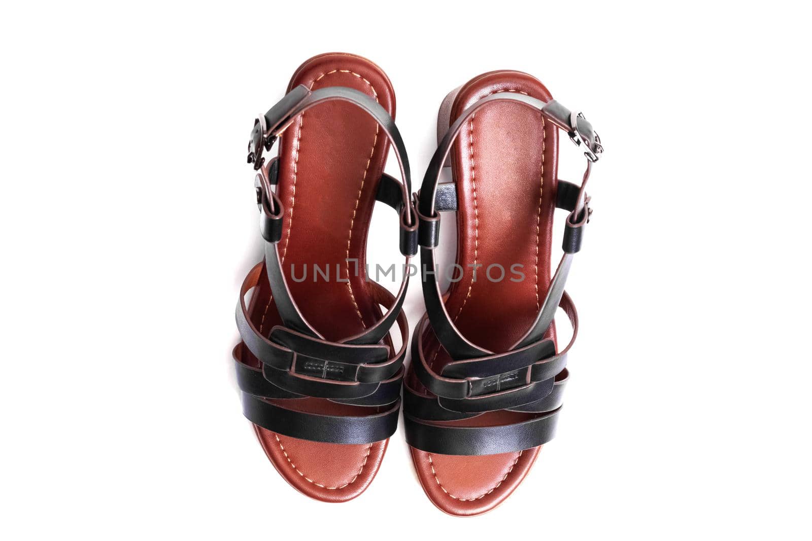 Women's black sandals with straps isolated on a white background close up