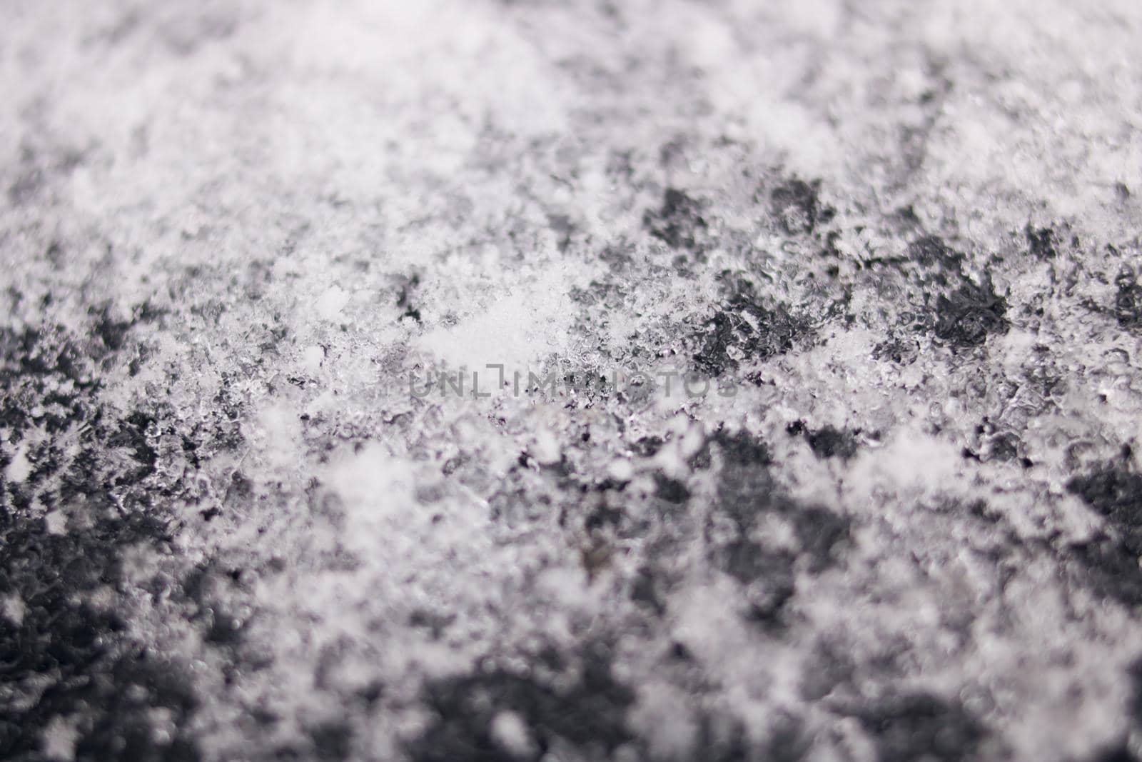 White snowflakes on black surface macro photo by Vera1703