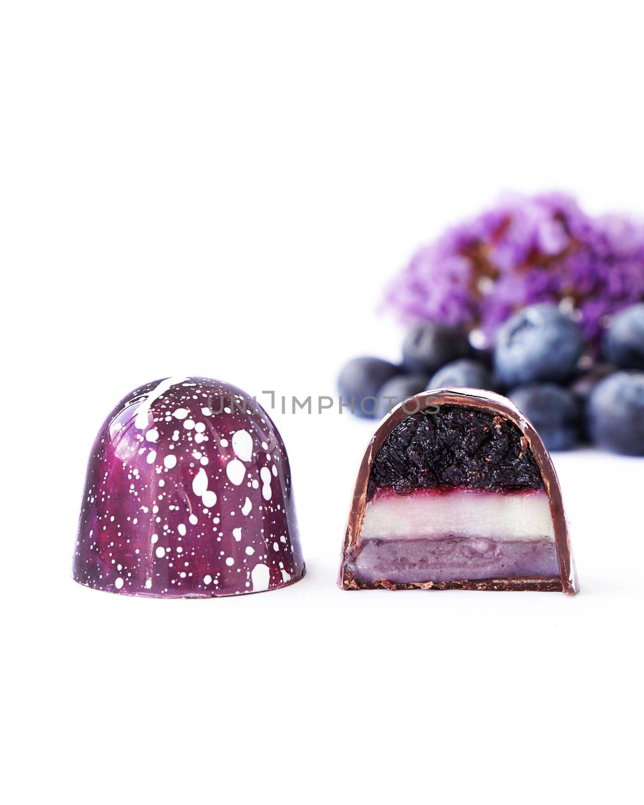 Chocolate candy in a cut on a white background. Blueberry and lavender by natali_brill