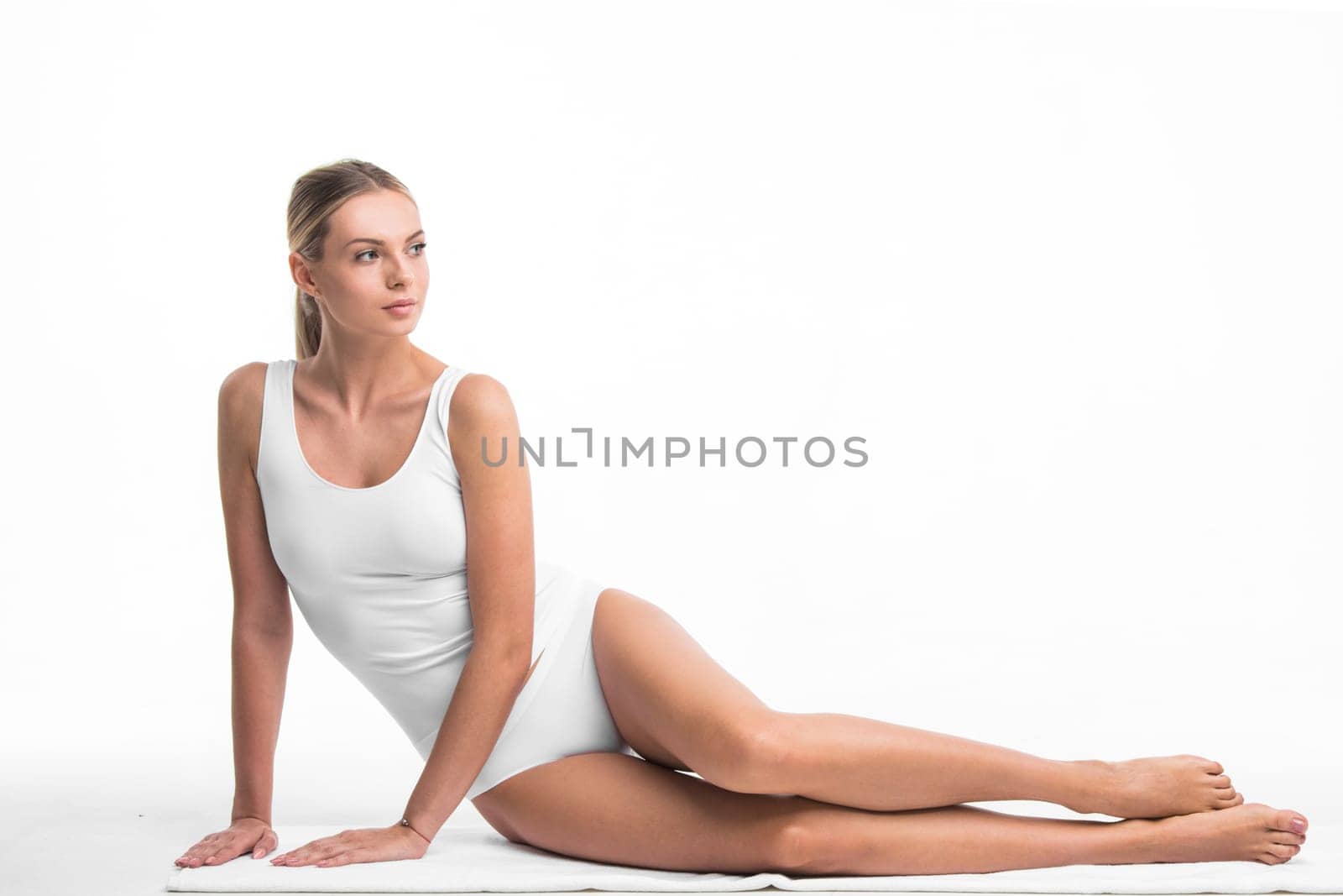 Attractive sensitive slim woman sitting in white cotton lingerie underwear isolated on white background