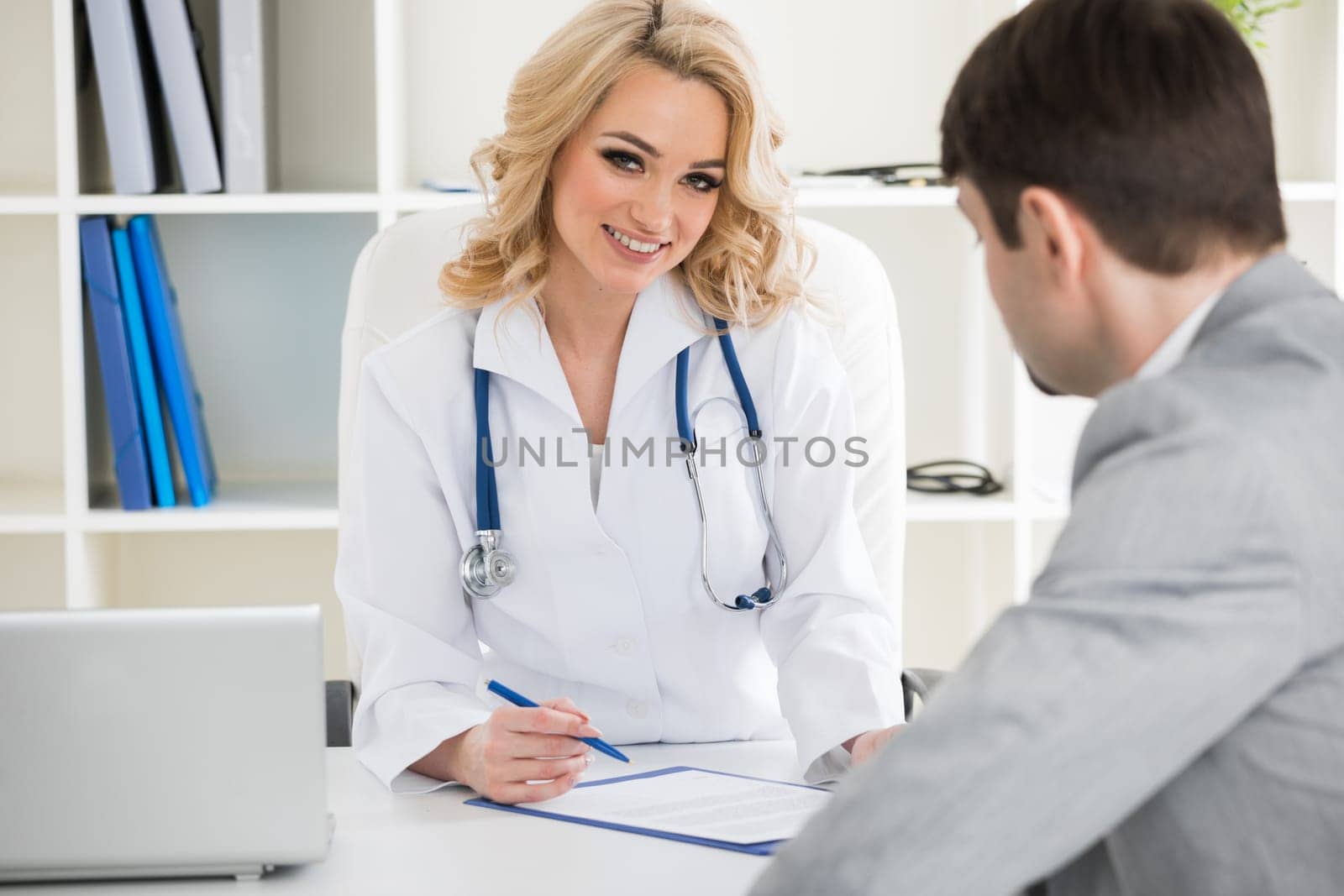 Doctor consulting patient in a clinical office