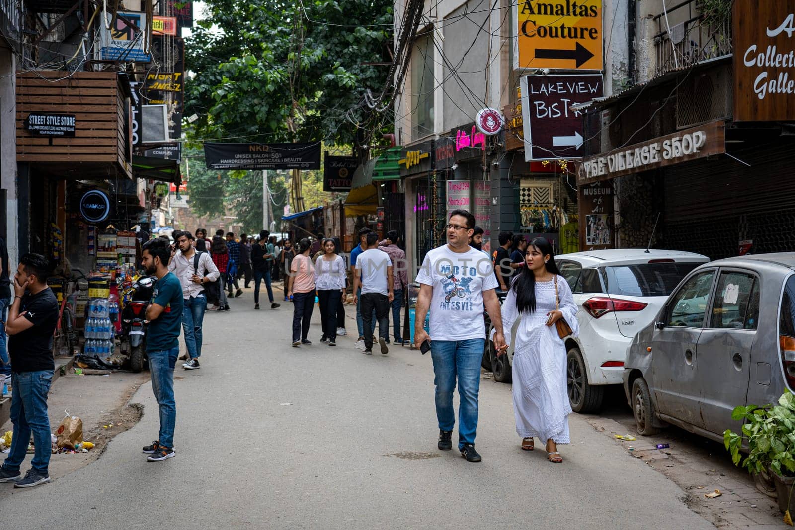 New Delhi, India - March 30, 2023: People and shops in Hauz Khas Village neighboorhoud
