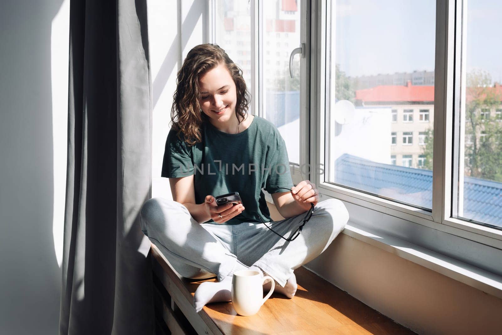 Modern Lifestyle: Woman Using Smartphone at Home - Female Student Engaged in Communication, Work, and Study, Embracing the Convenience of Mobile Apps and Technology