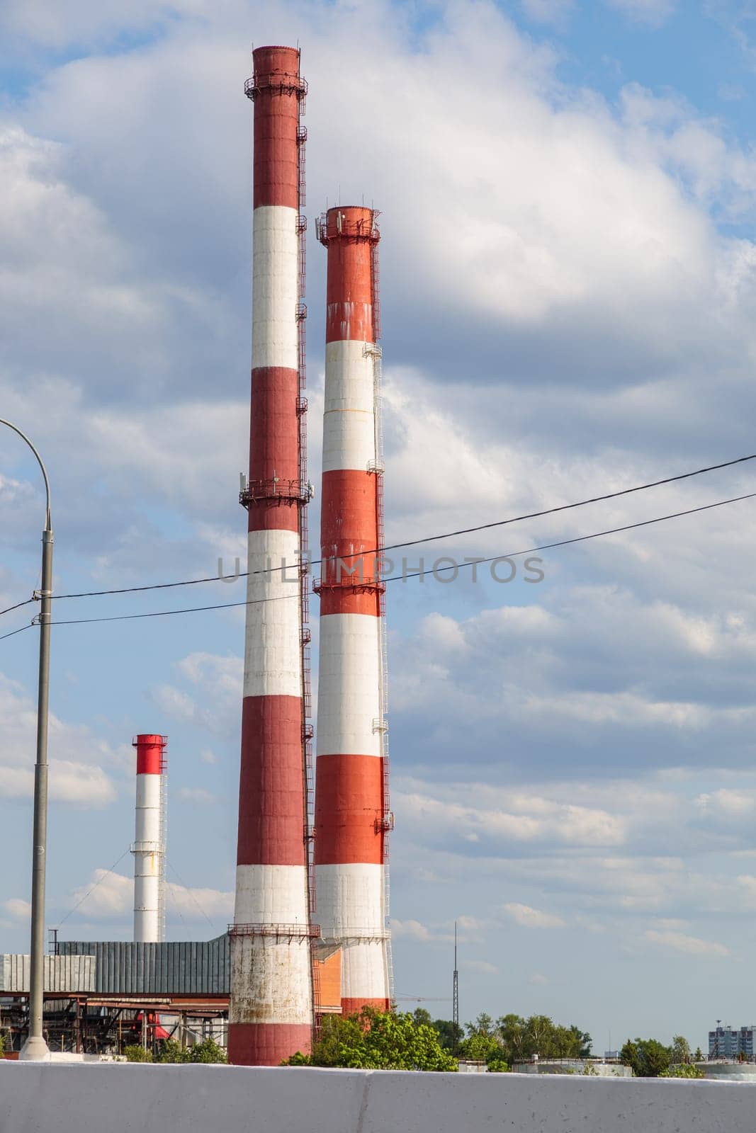 Industrial plant with tall chimneys against the blue sky. High quality photo