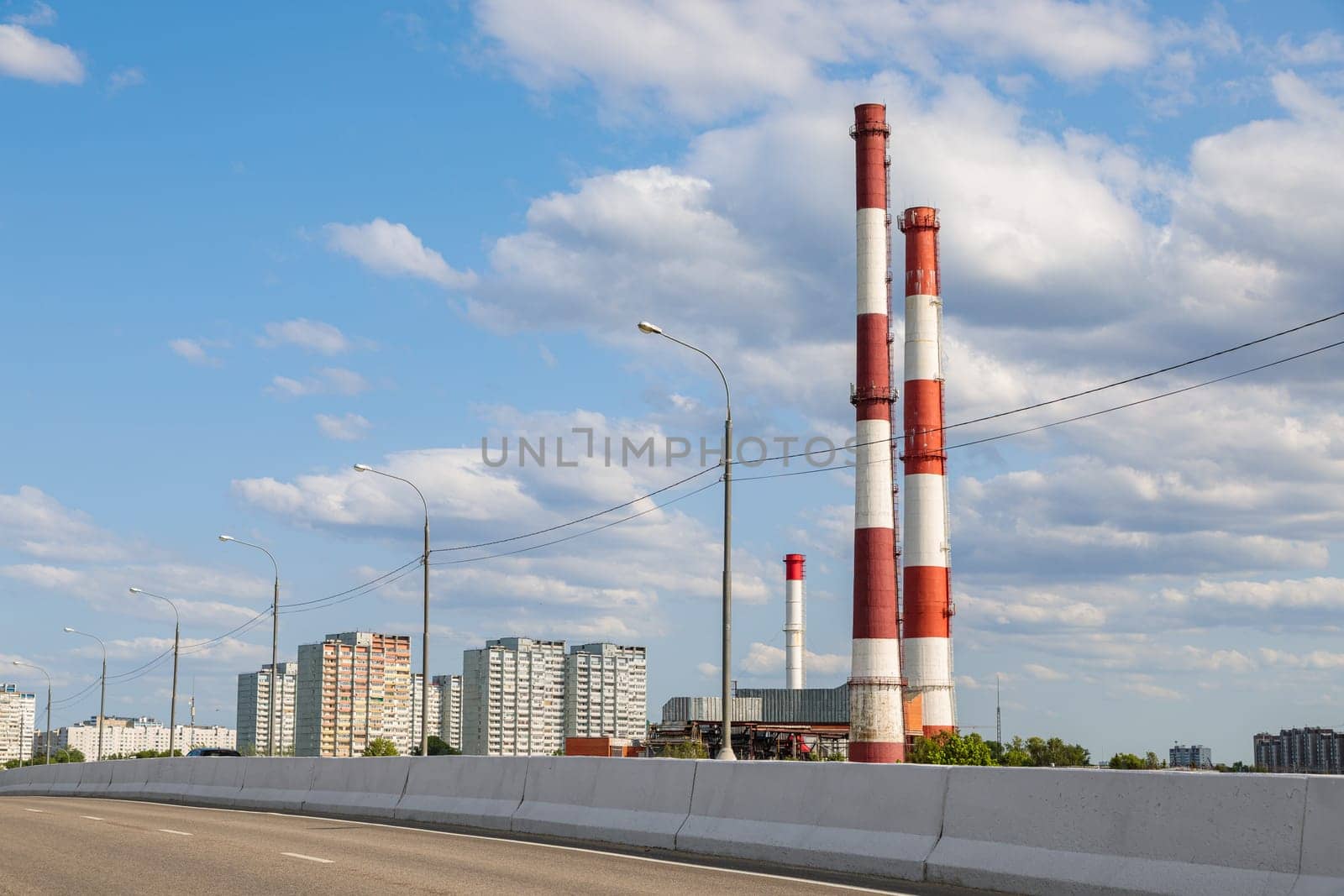 Industrial plant with tall chimneys against the blue sky. by Yurich32