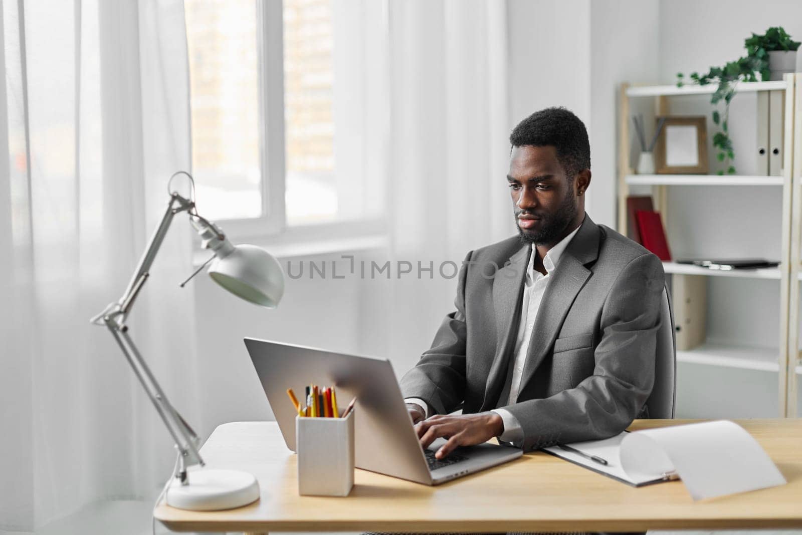 student man technology laptop american african job freelancer computer education online office by SHOTPRIME