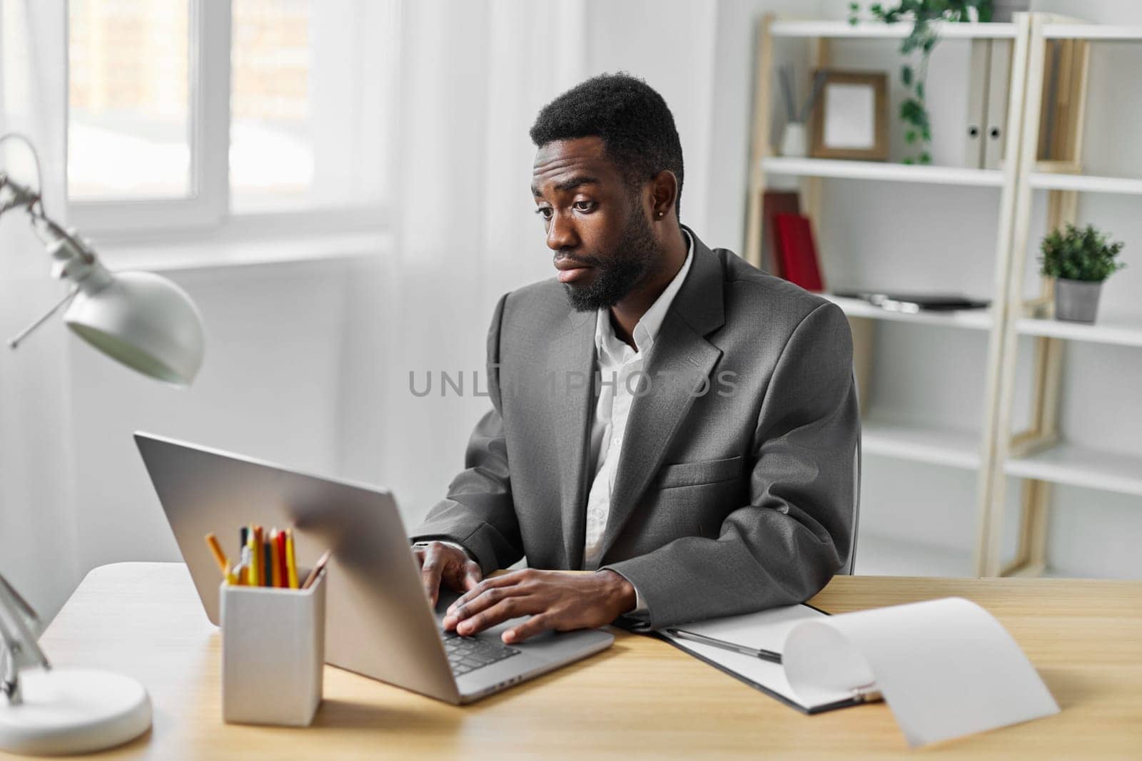 laptop man indoor online freelancer african office american computer student education job by SHOTPRIME